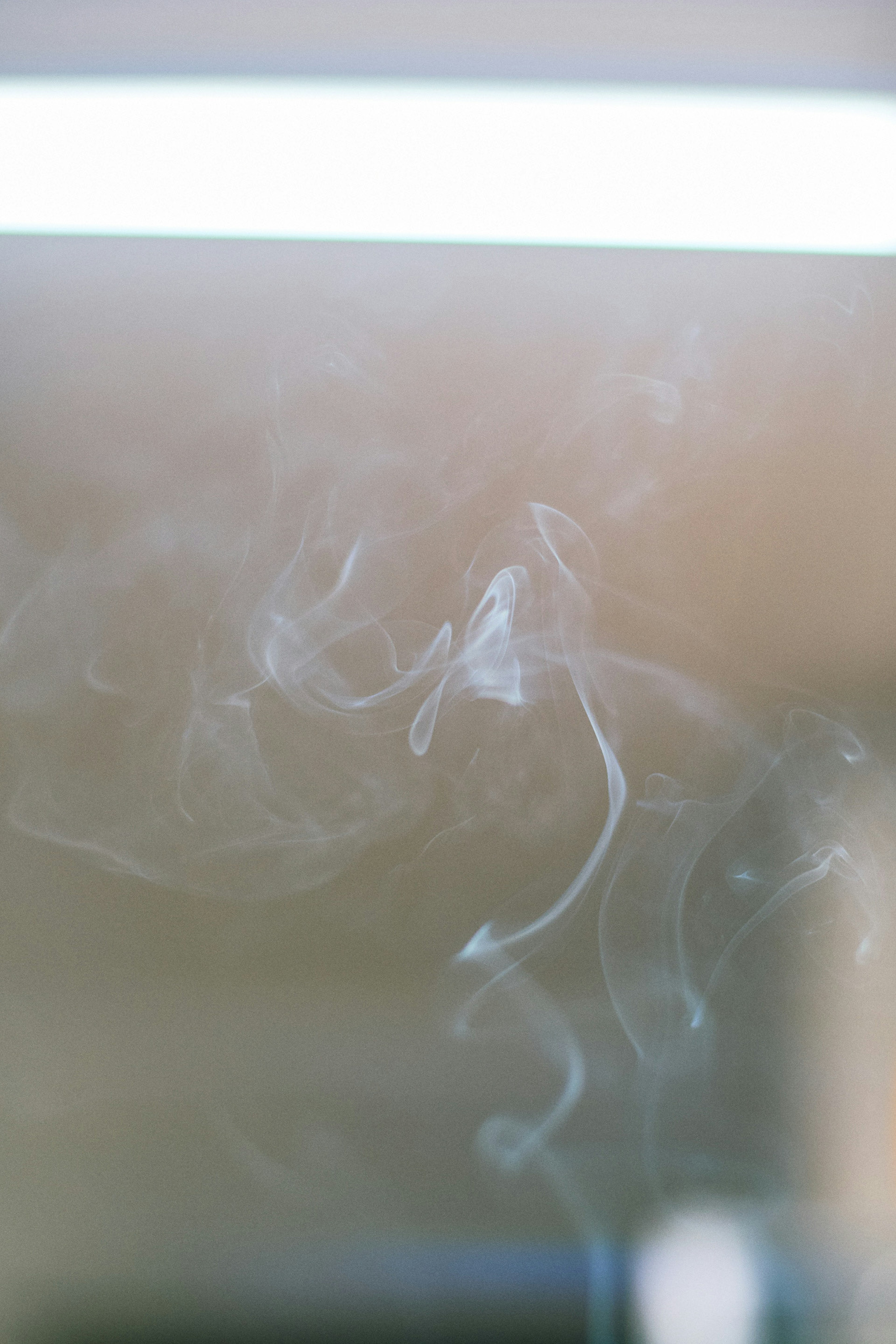 White smoke swirling against a soft background