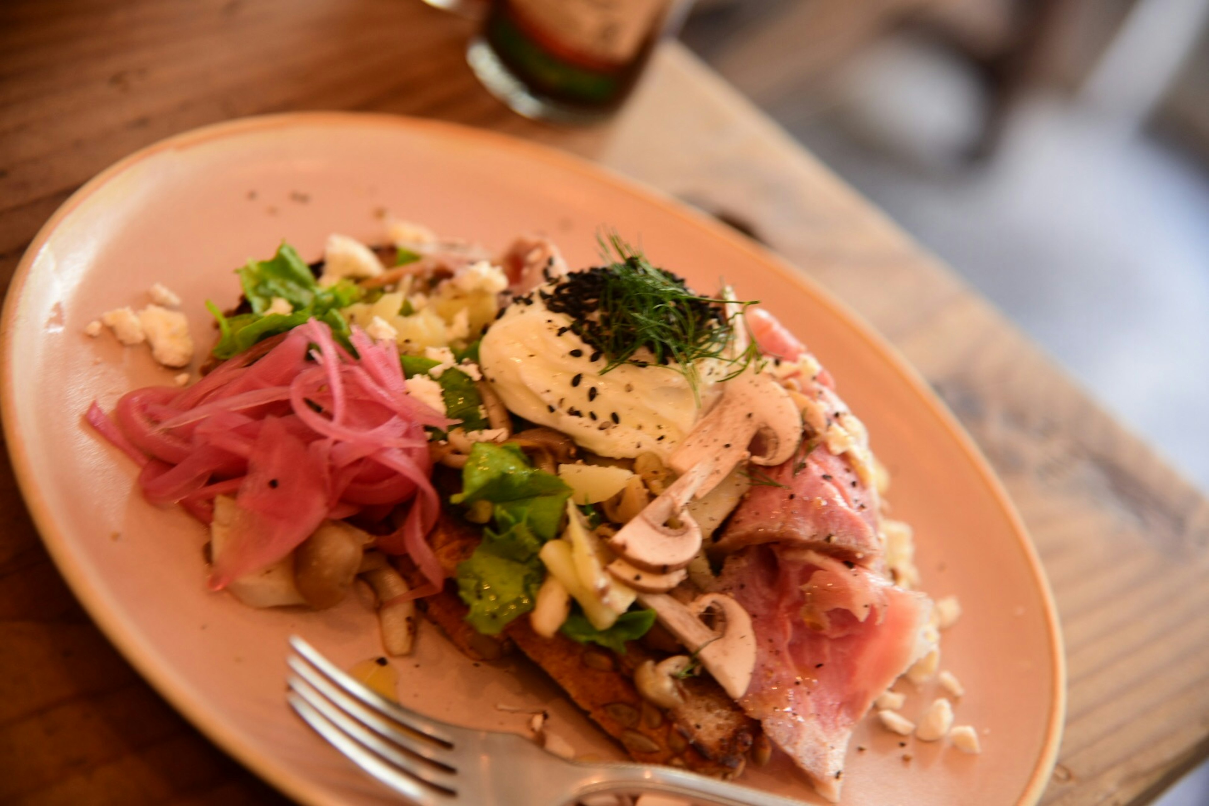 Plate of toast topped with salad and ham