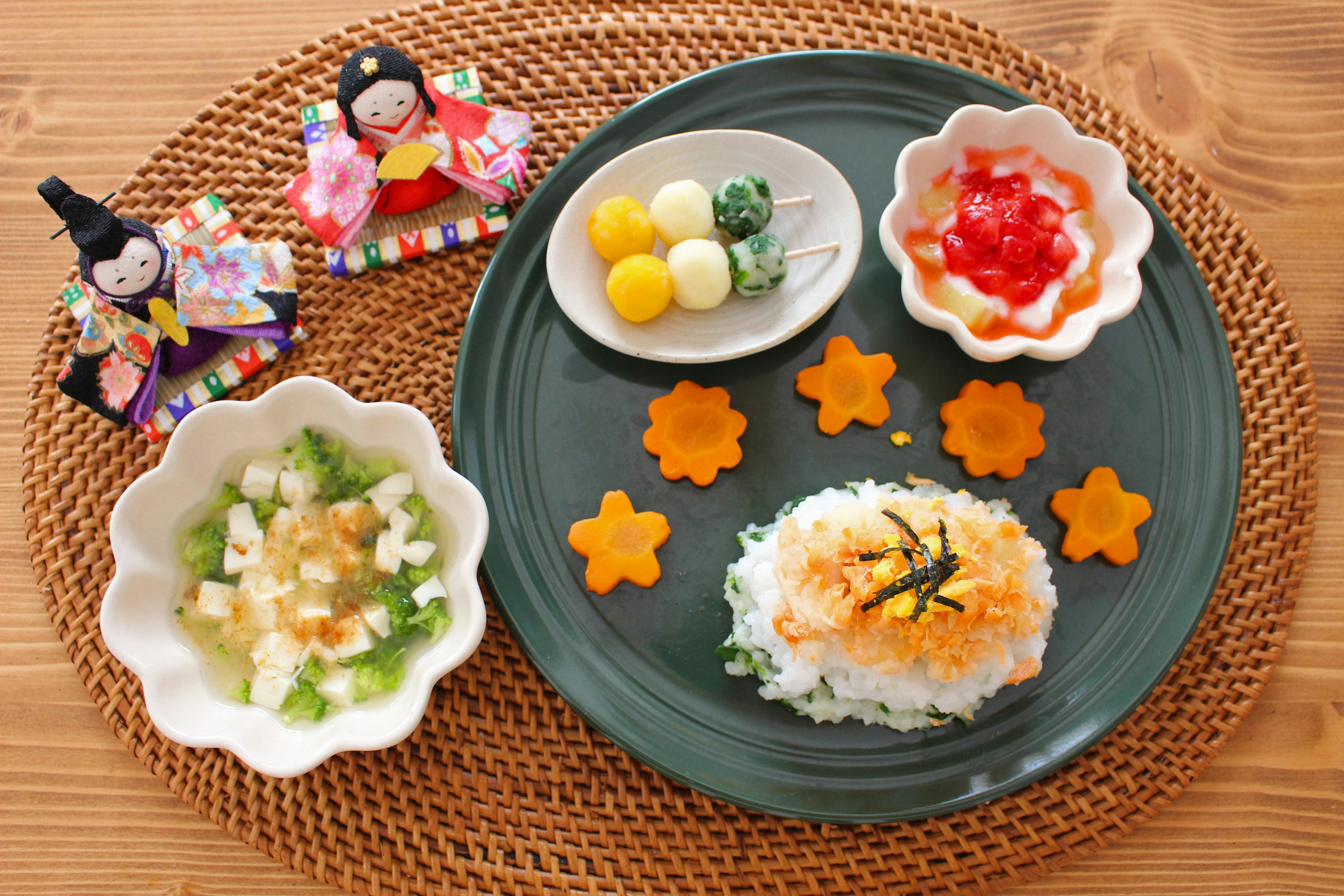 Colorful Japanese meal plate featuring decorative carrots and small bowls