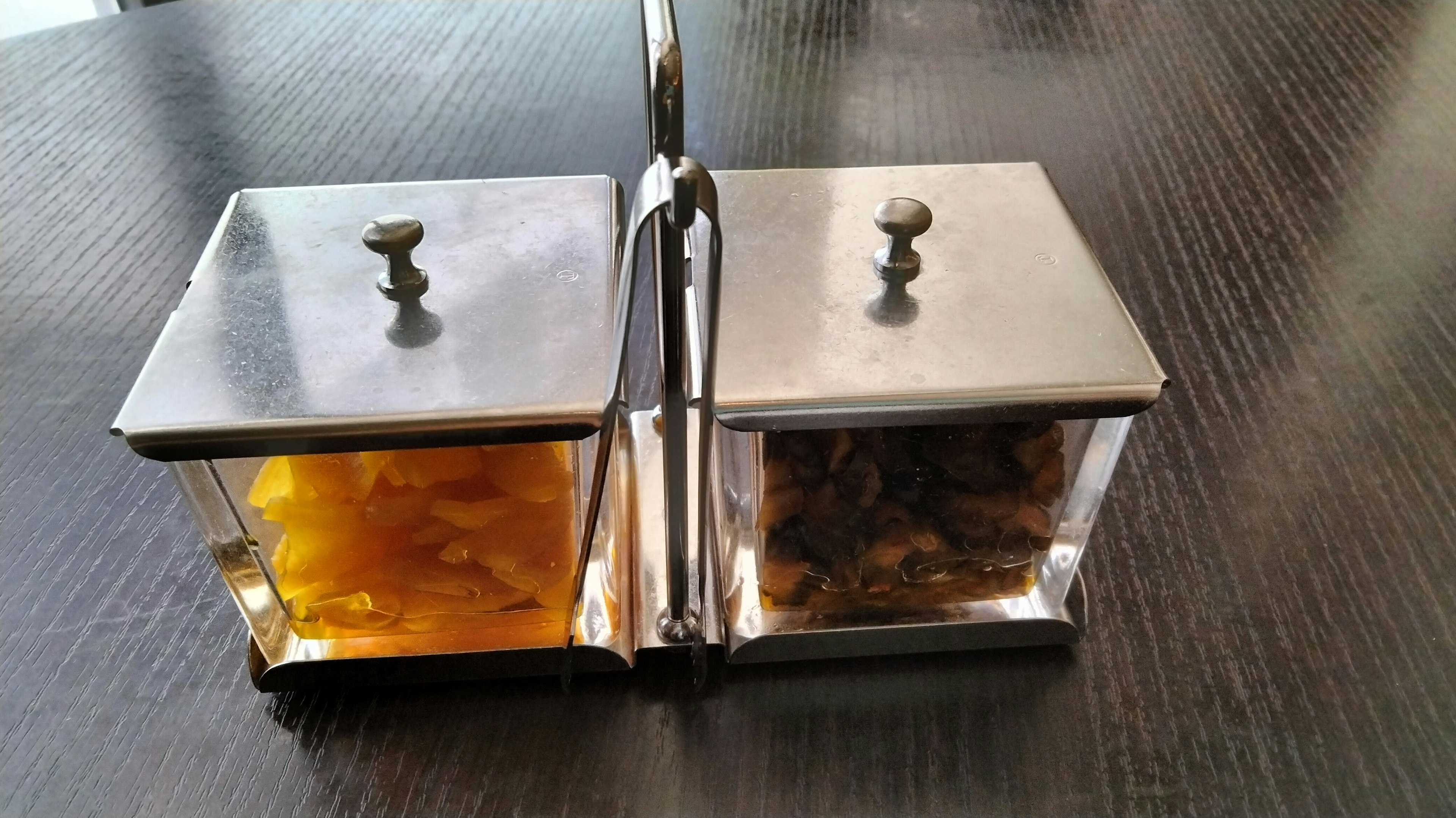 Metal containers holding dried fruits and nuts