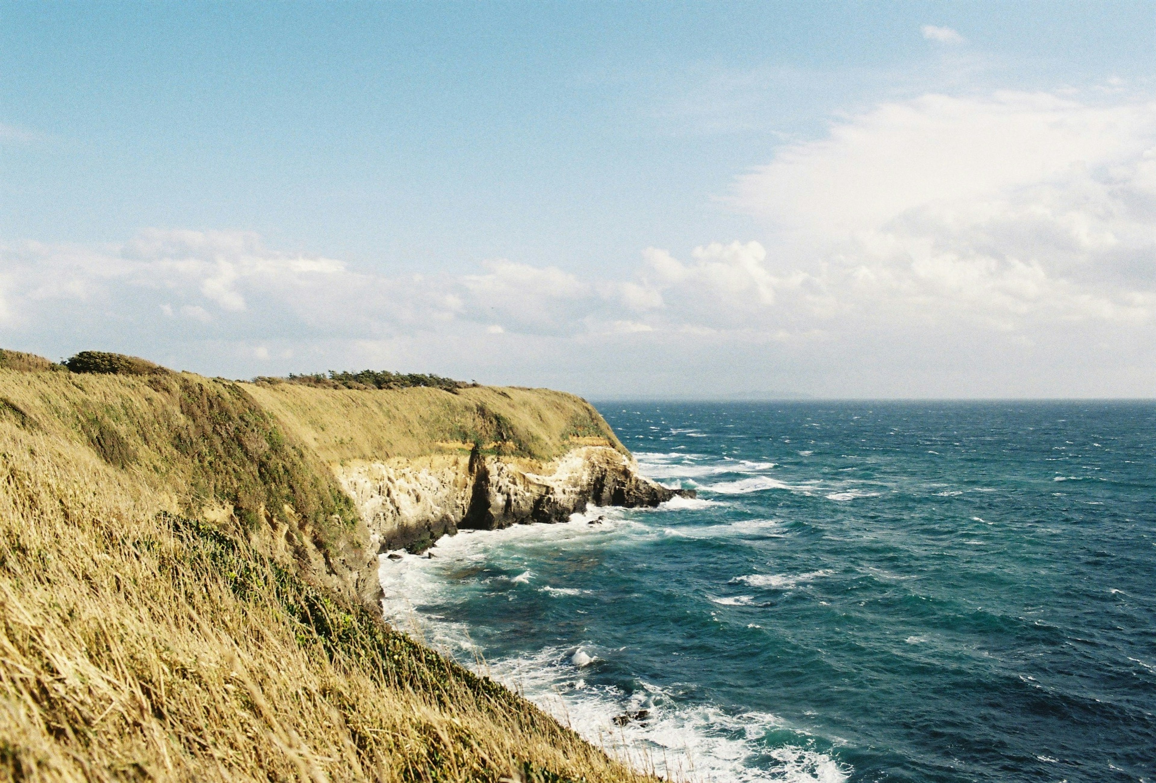 Coastal landscape featuring cliffs and blue ocean