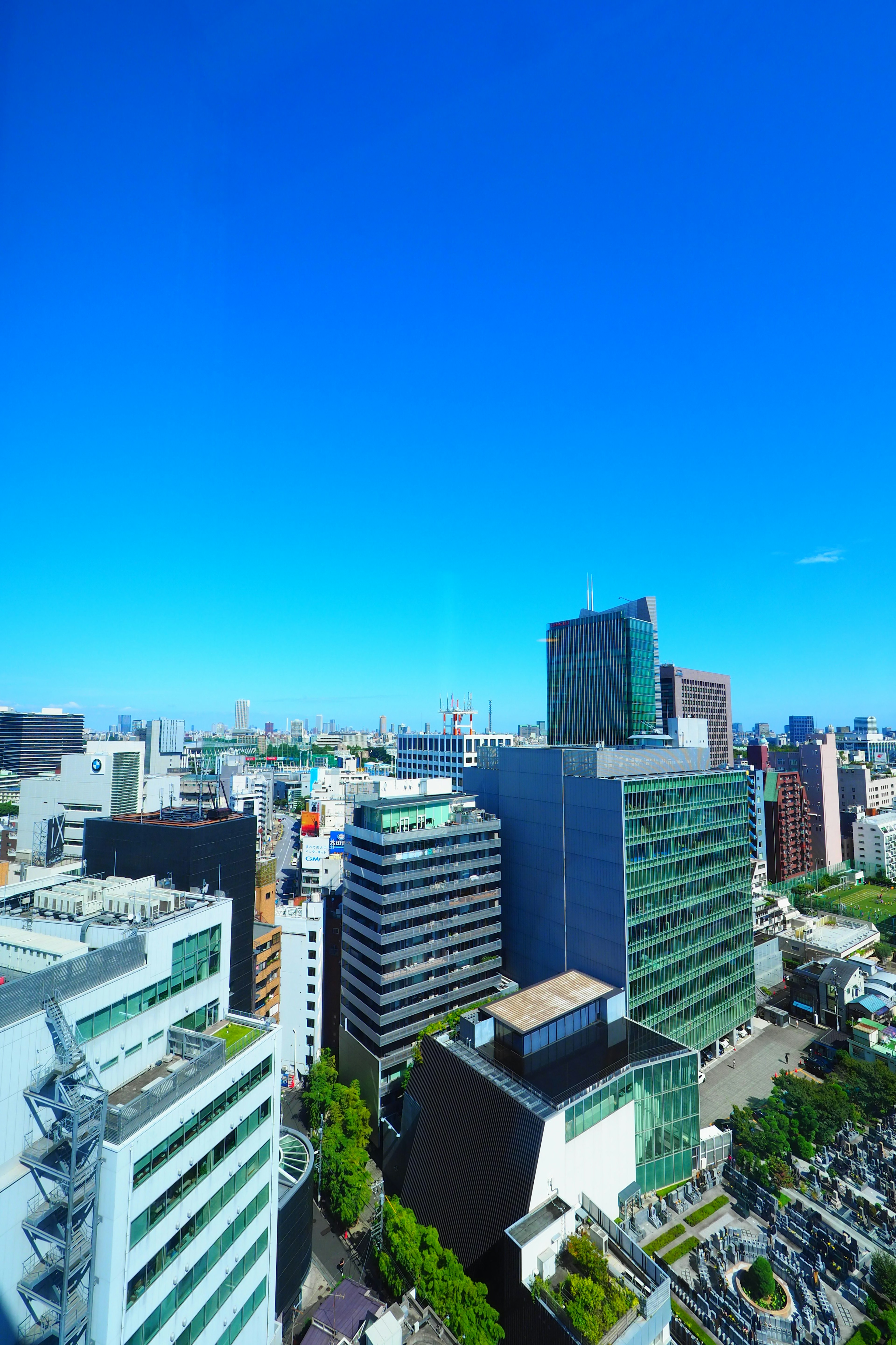 Urban skyline featuring tall buildings under a clear blue sky