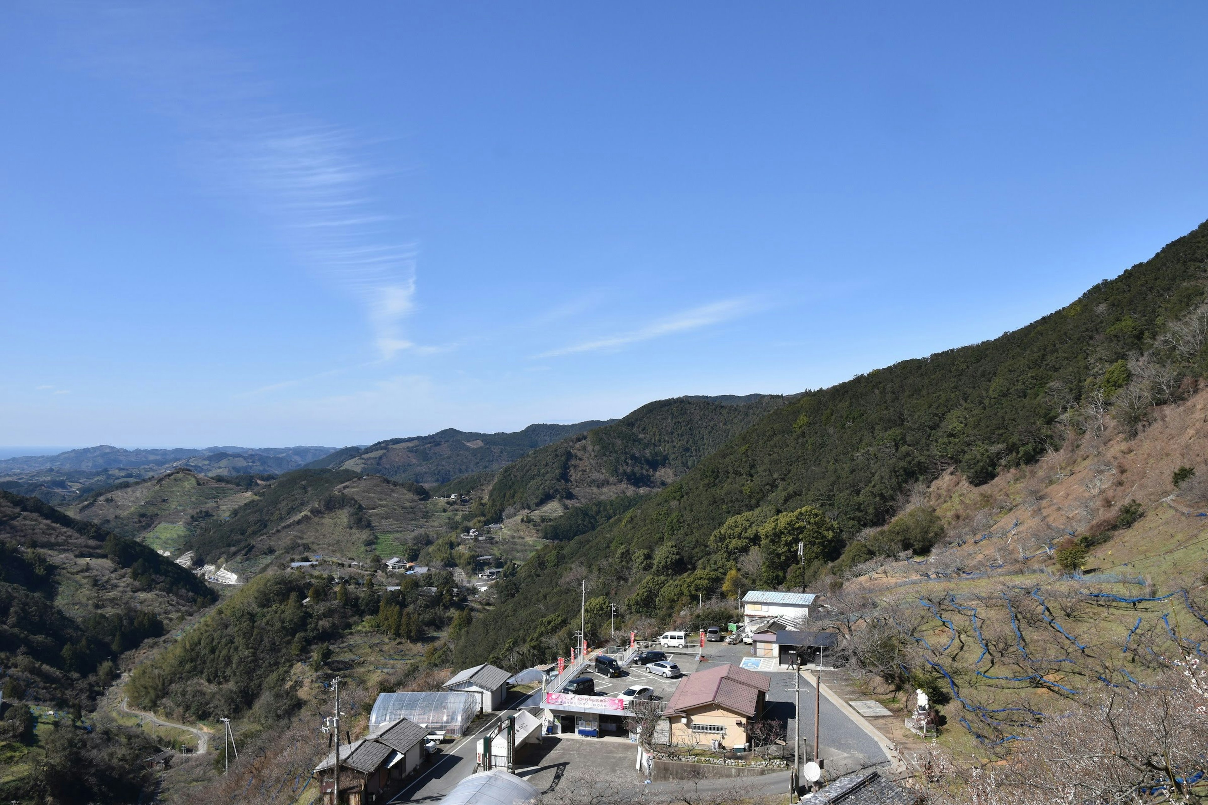 Scenic view of a village in the mountains with clear blue sky