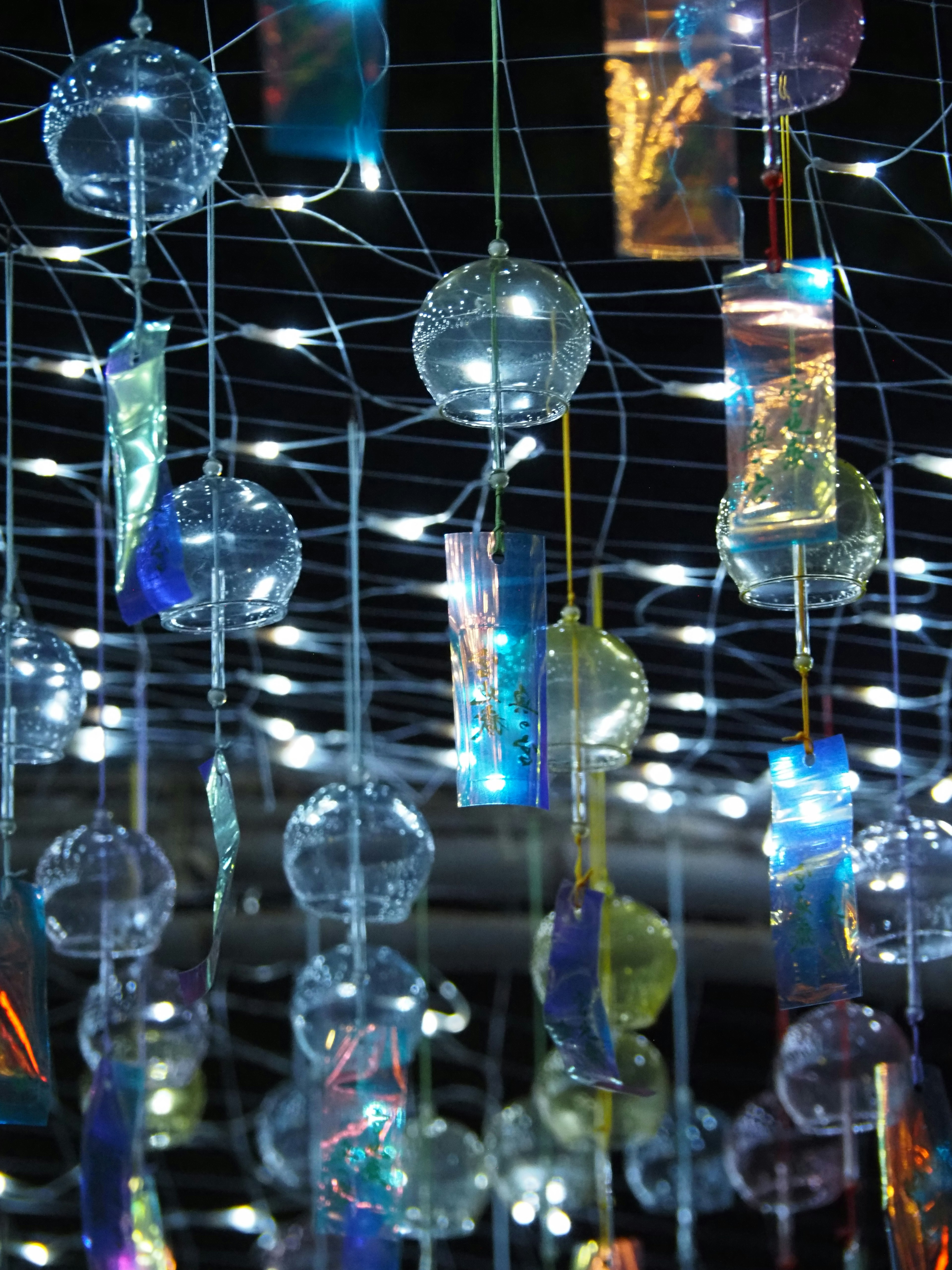 Colorful transparent objects hanging in a night sky decoration