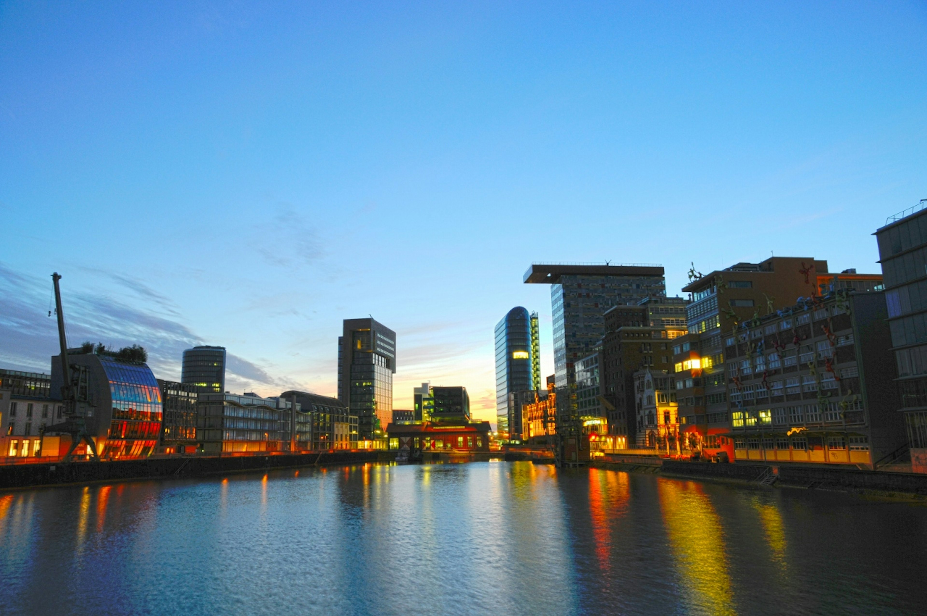 City skyline at dusk with reflections on the water