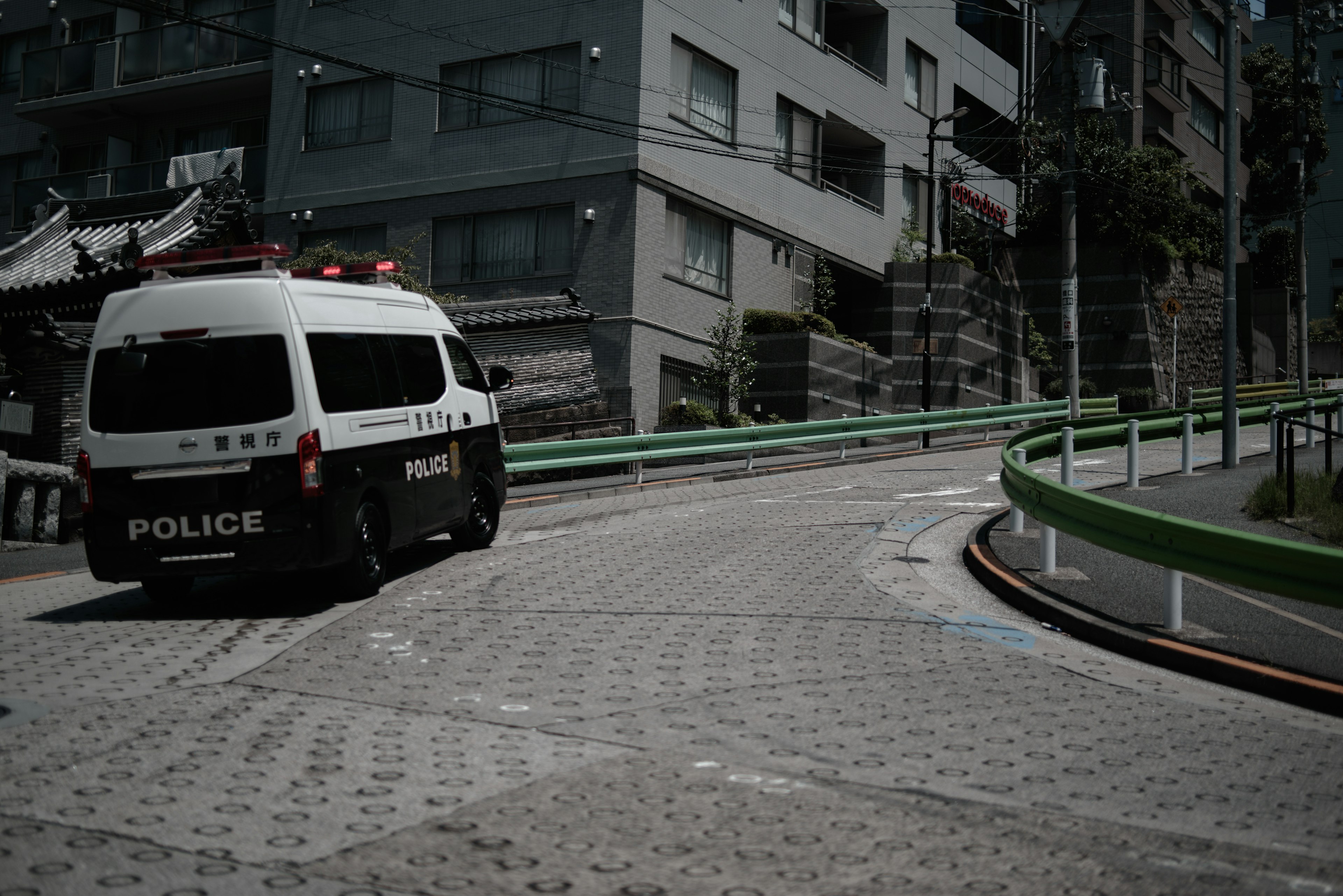 Police vehicle navigating a curved road in an urban setting