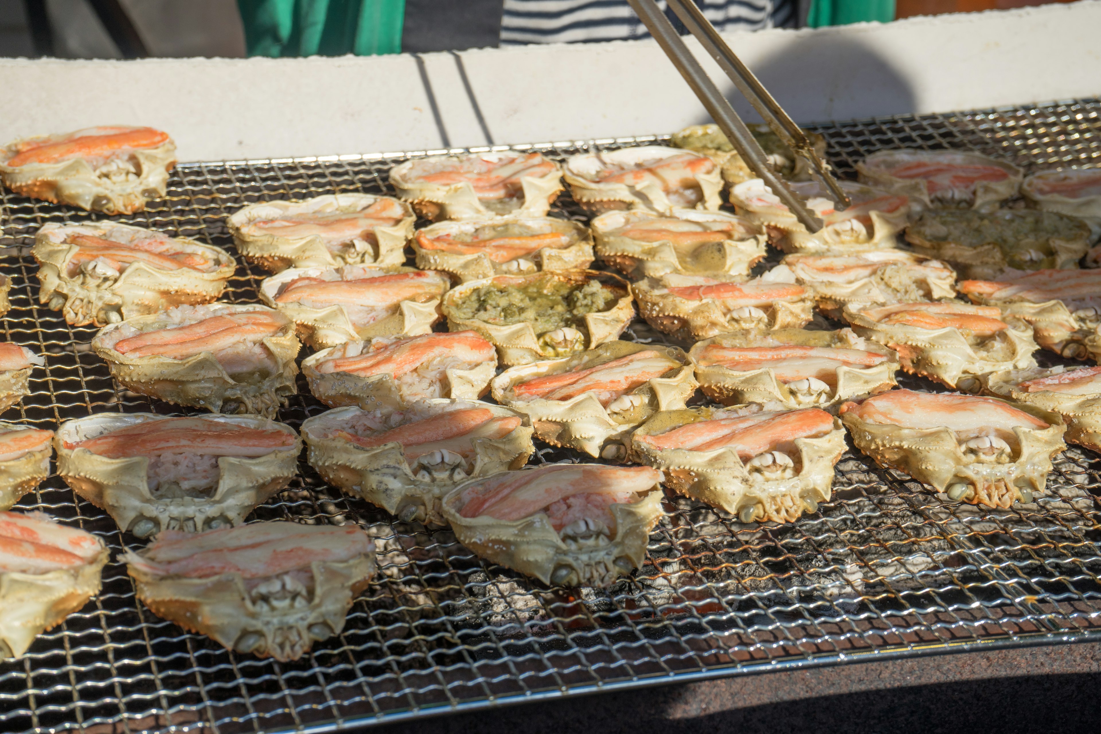 Huîtres grillées disposées sur une grille en plein air