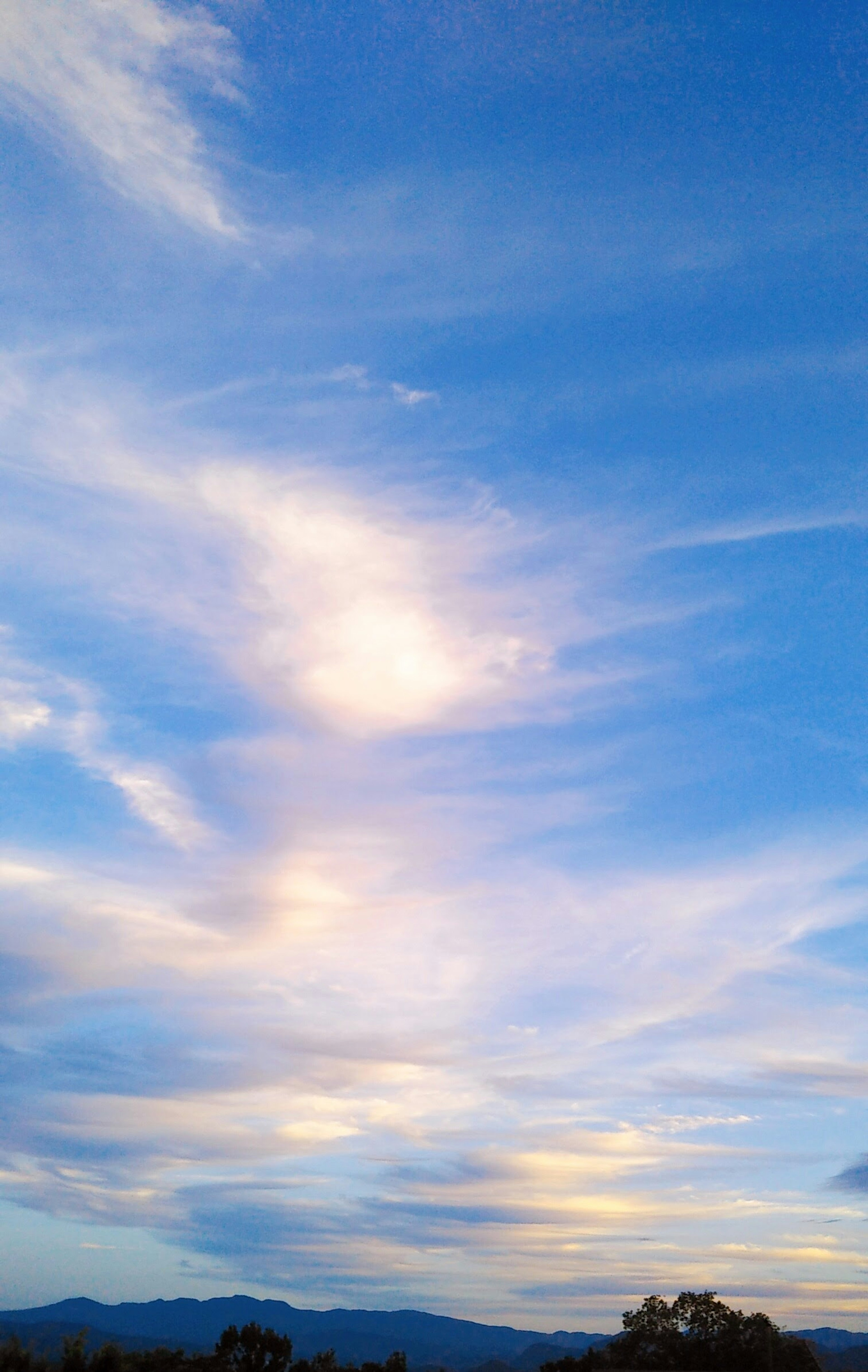 Soft clouds spread across a blue sky creating a serene landscape