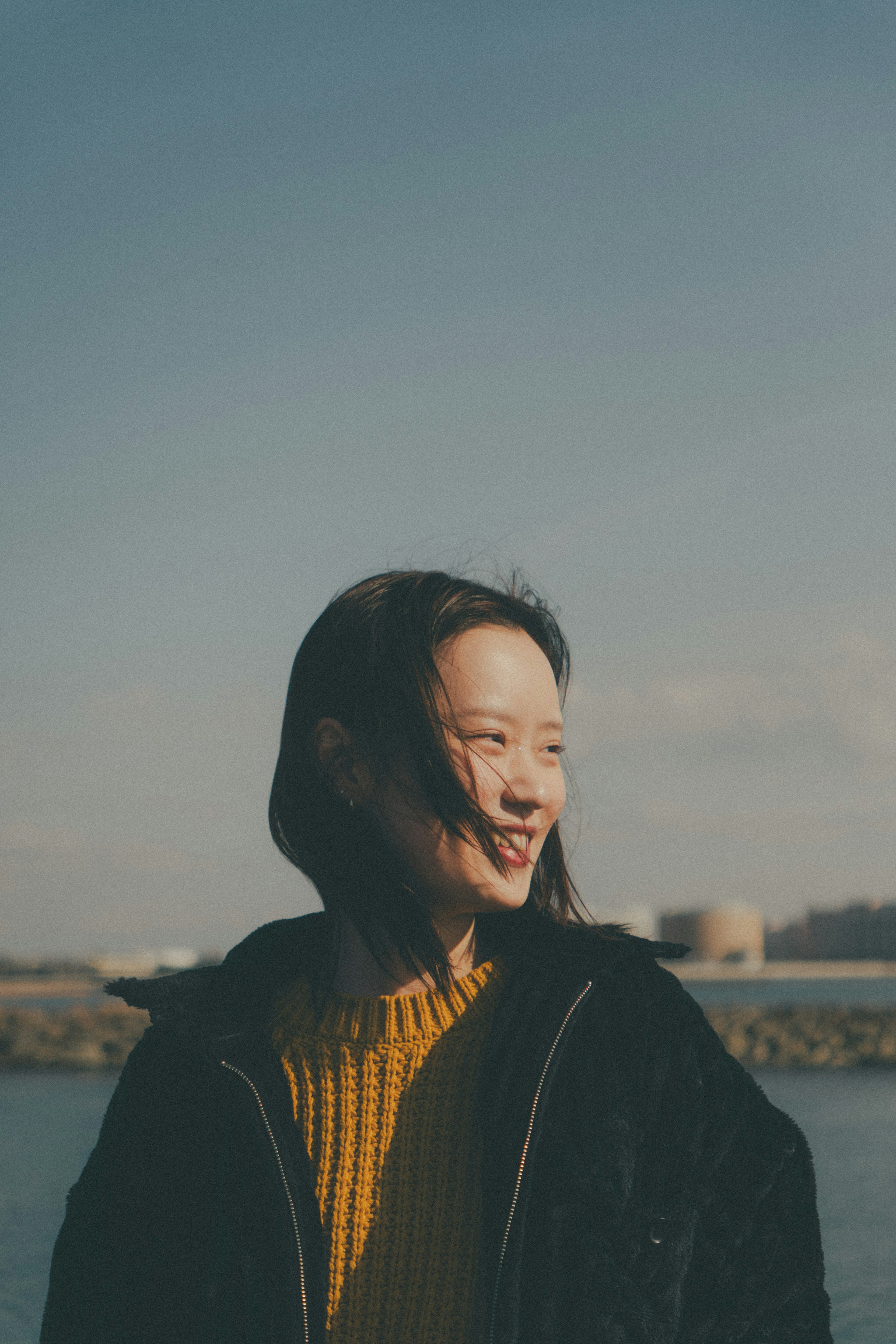 海辺で笑顔を見せる女性の肖像