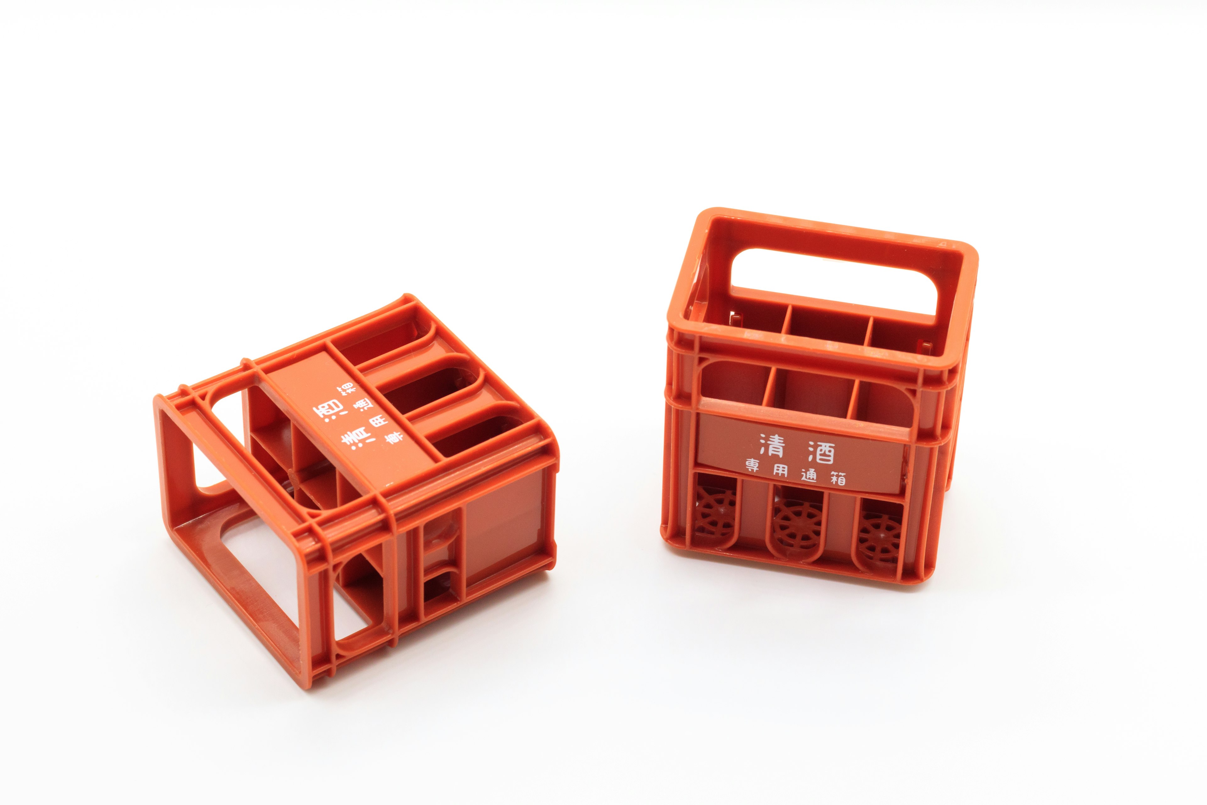 Two small orange plastic storage crates positioned next to each other