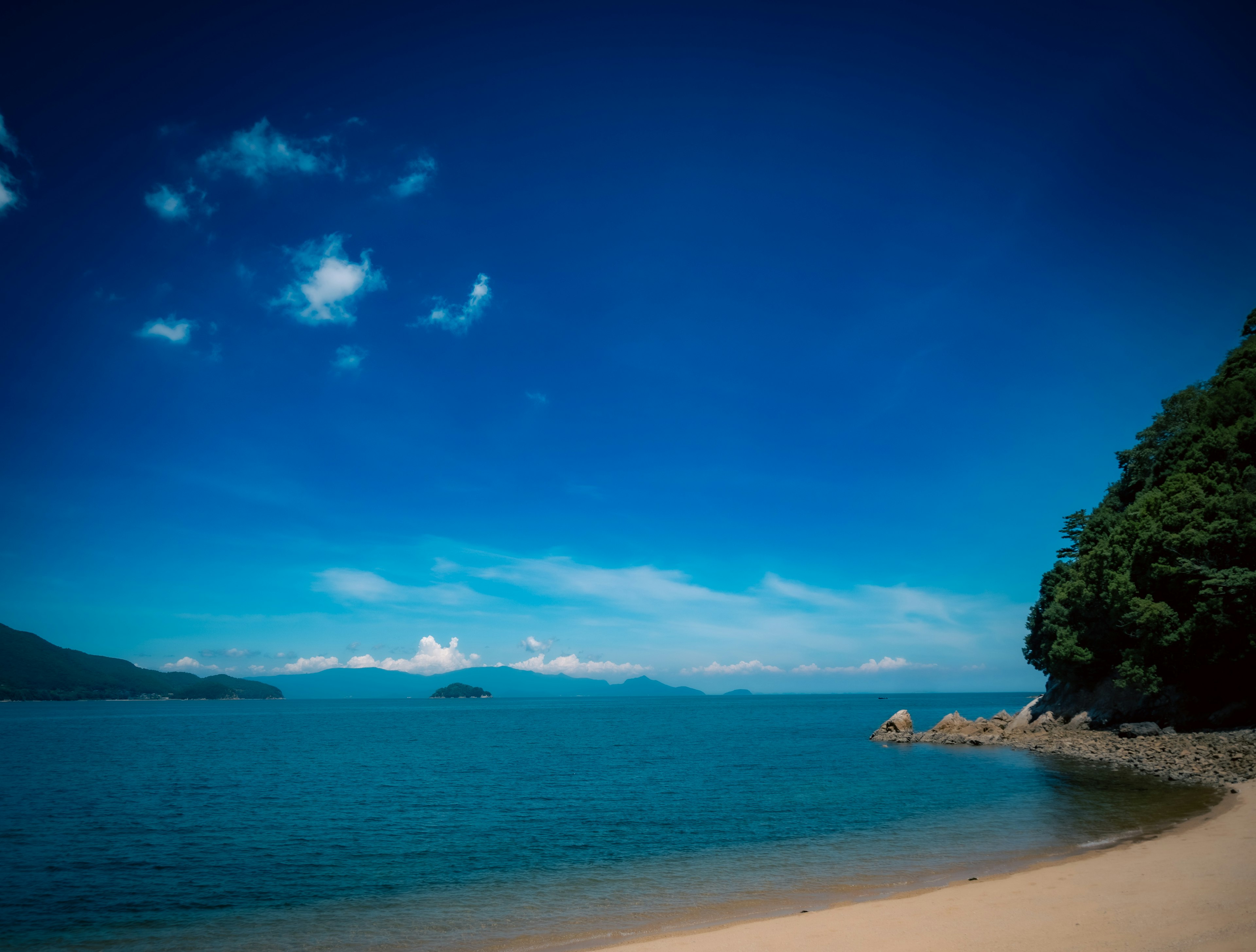 Pemandangan pantai yang indah dengan langit biru dan laut tenang