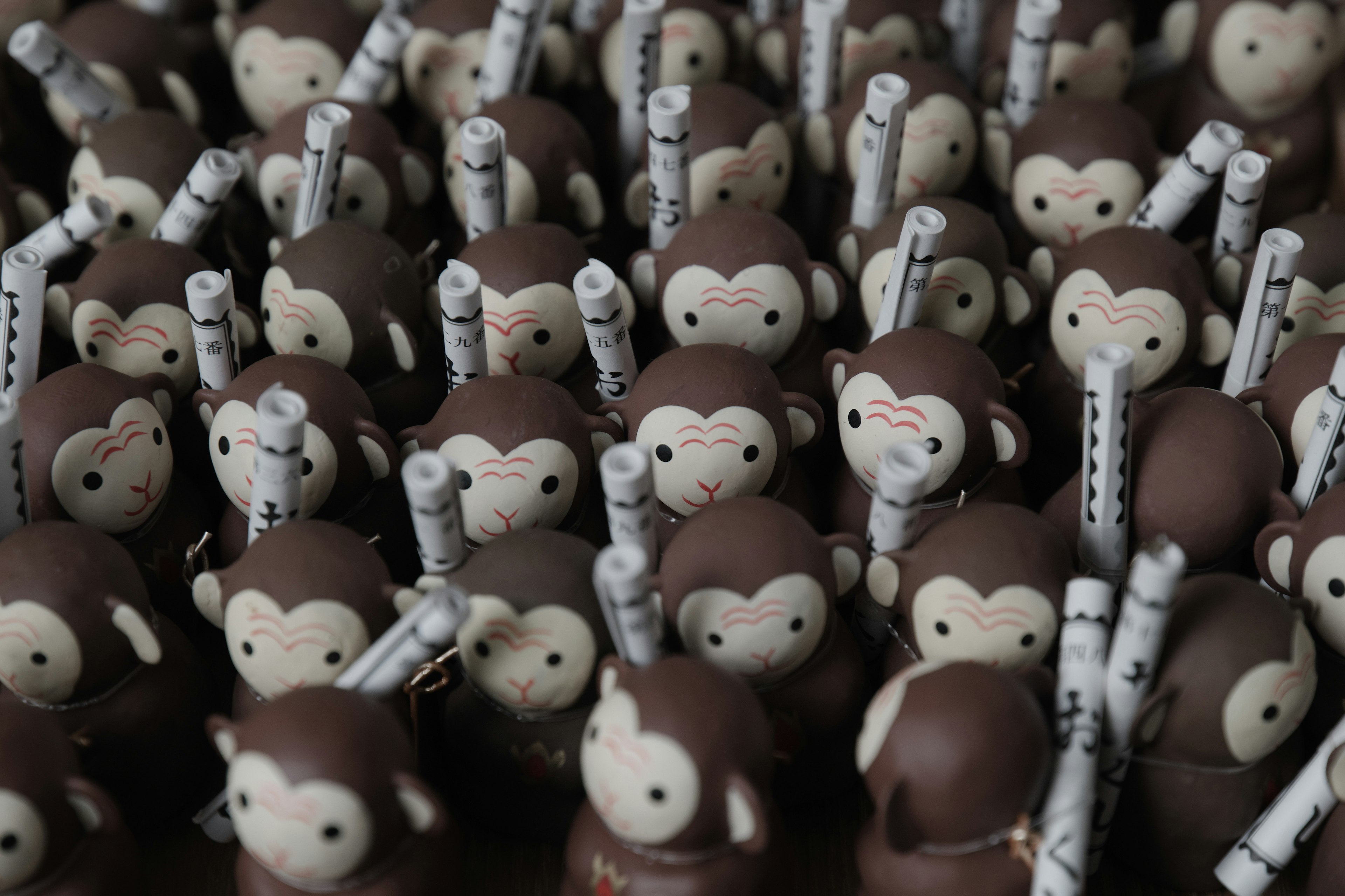 A crowd of brown monkey figurines with unique features