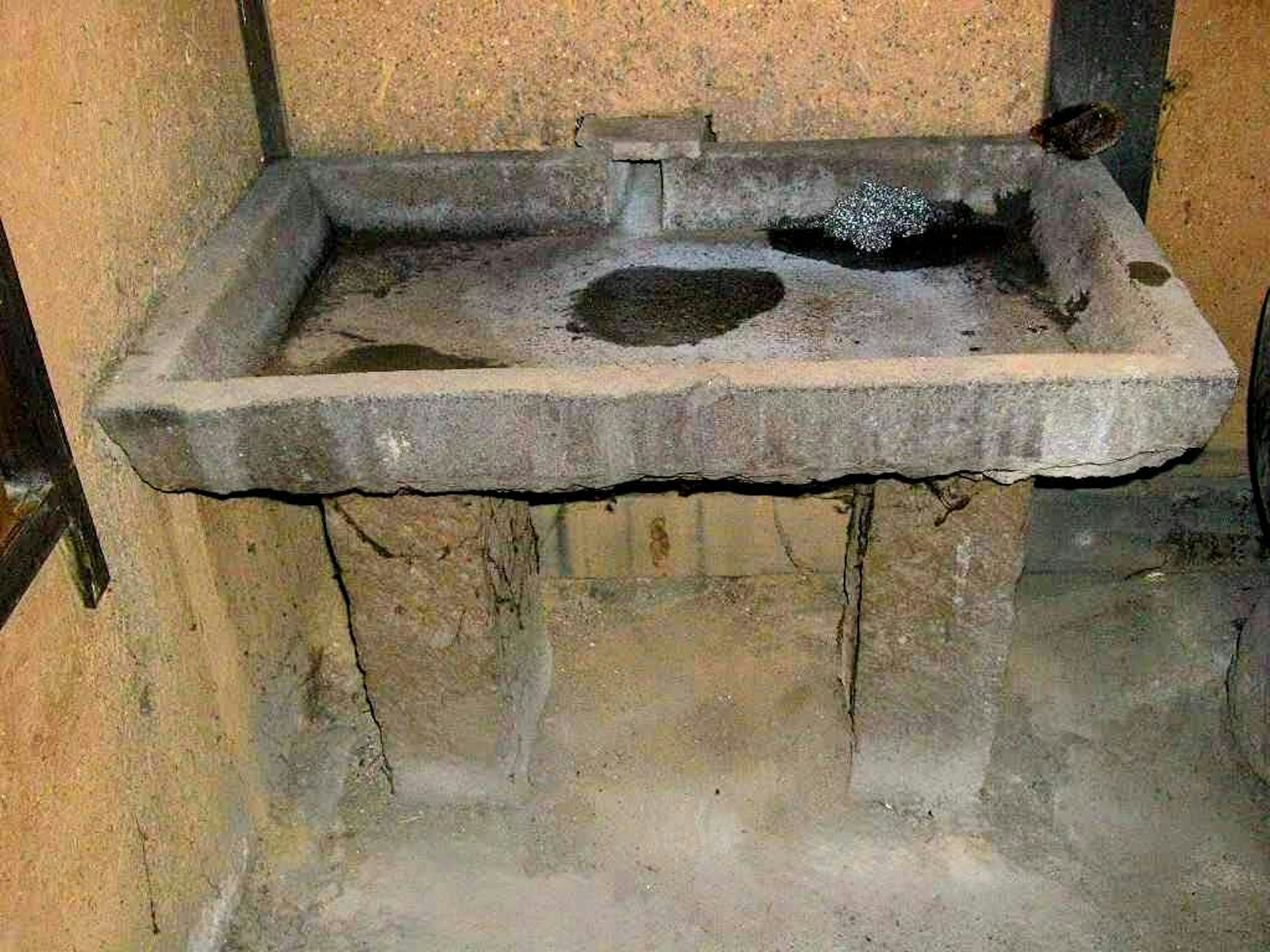 Old concrete sink mounted on a wall