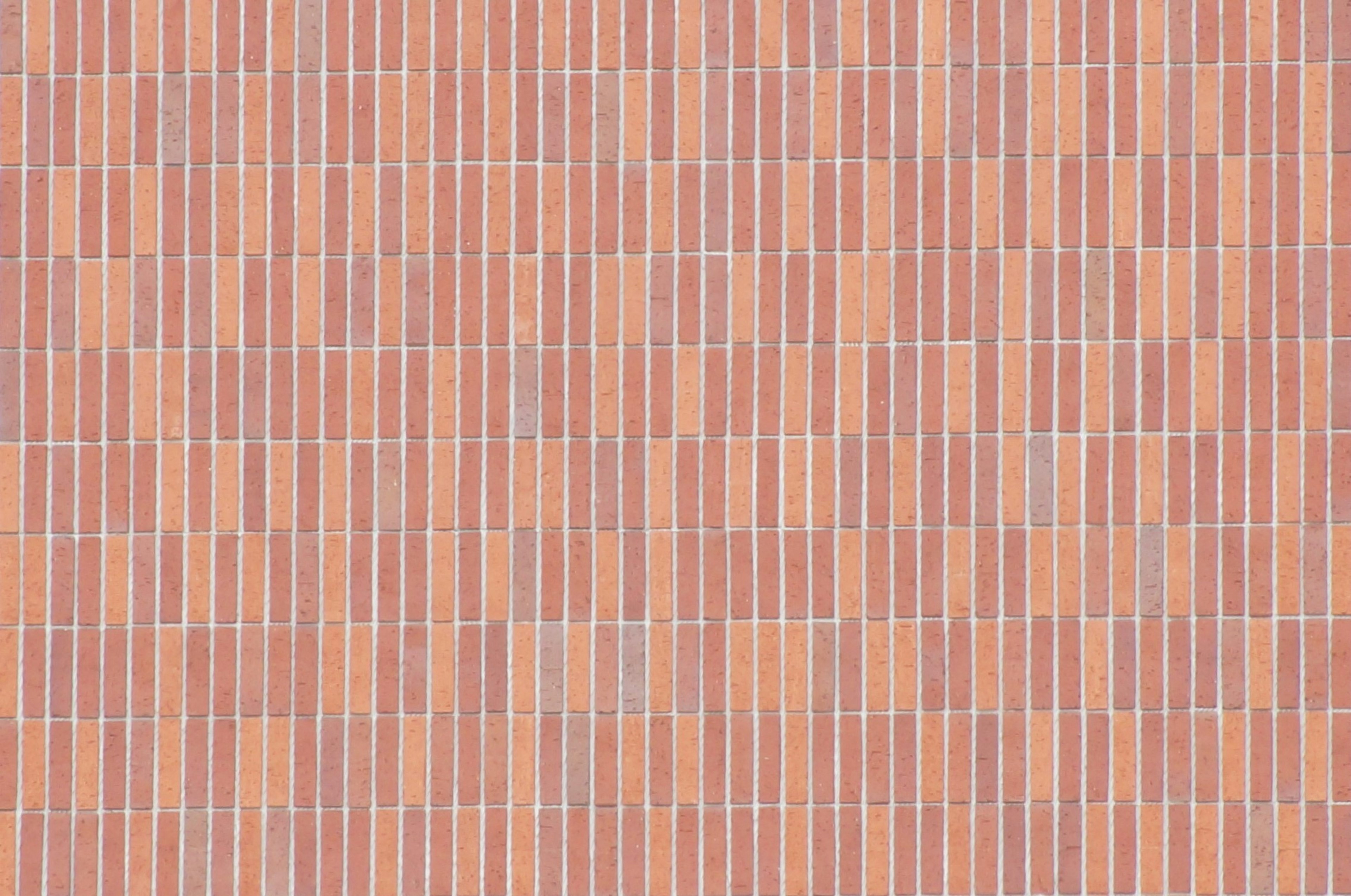 Uniform texture of a red brick wall with vertical lines