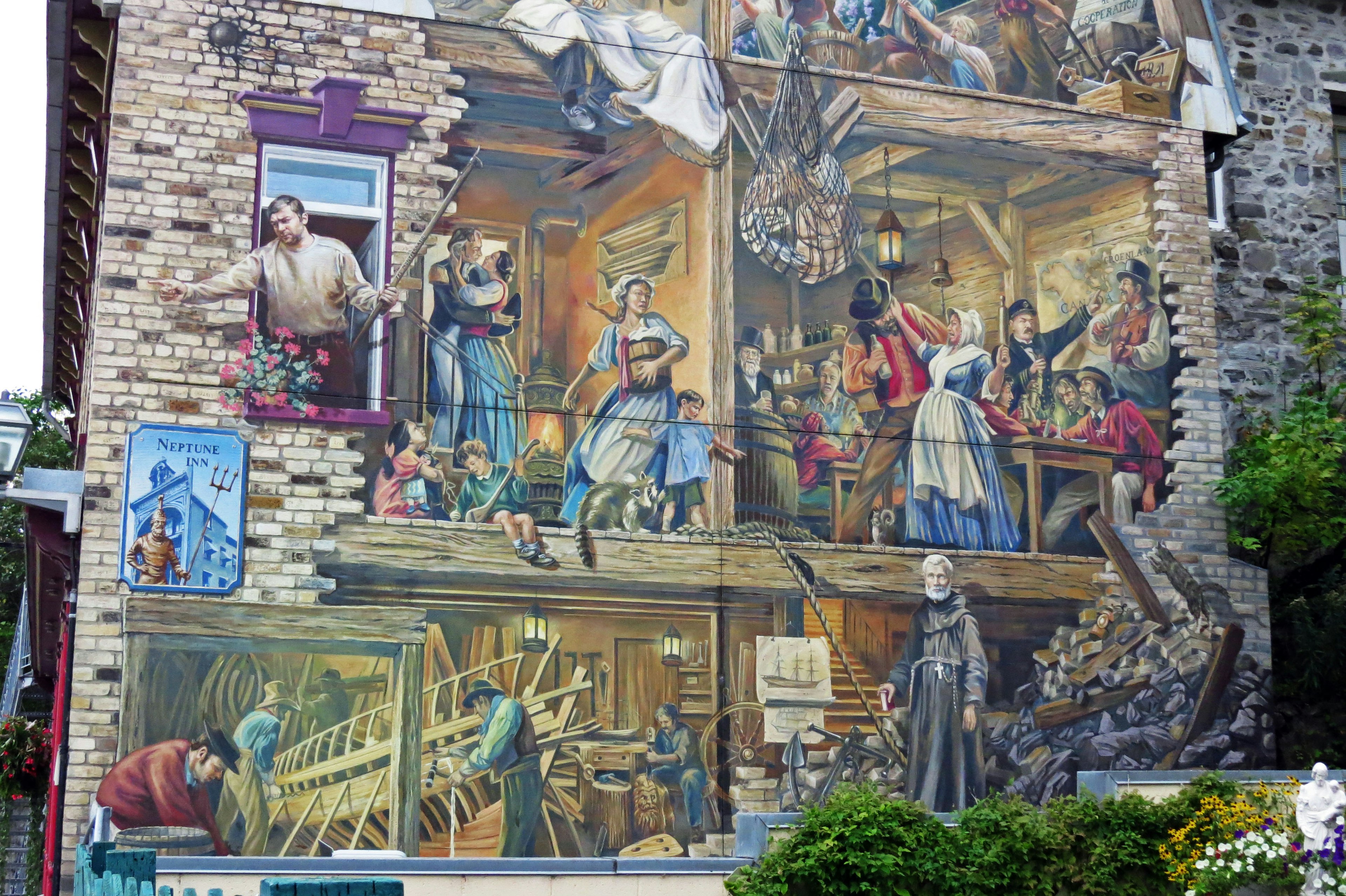 Vibrant mural on a building depicting various scenes of daily life