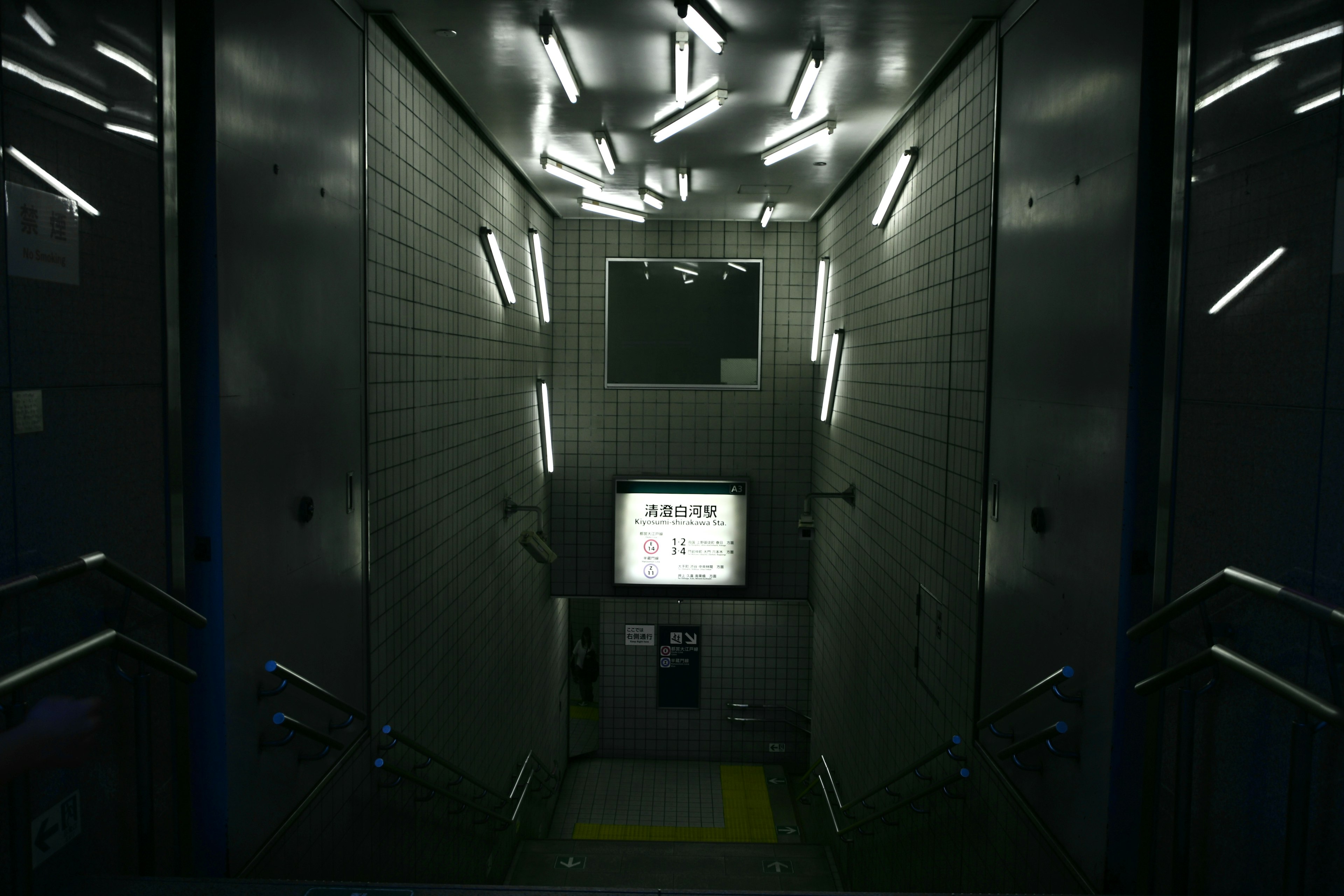 Image of a dark elevator shaft with bright overhead lighting