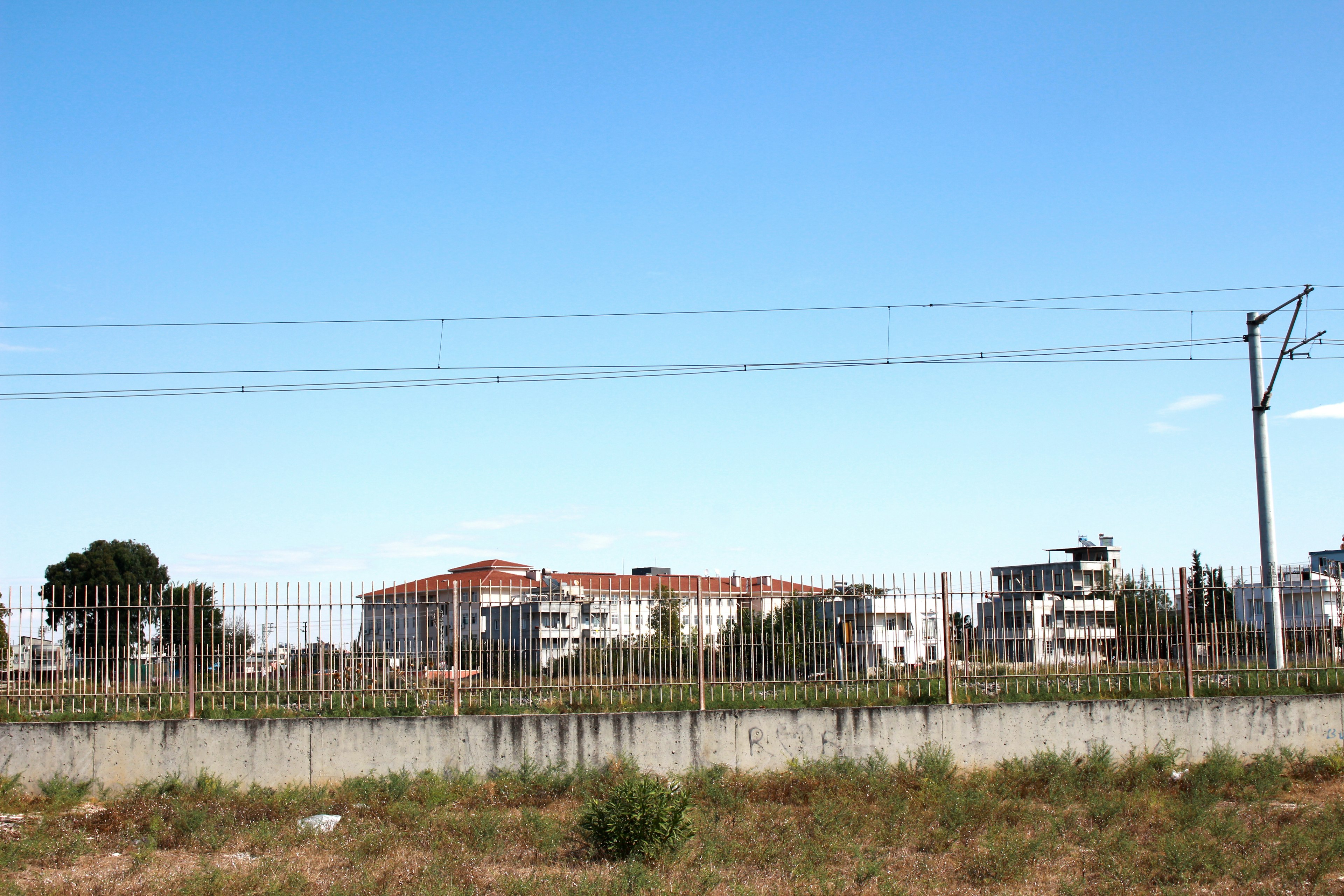 Residential area with a fence under a clear blue sky