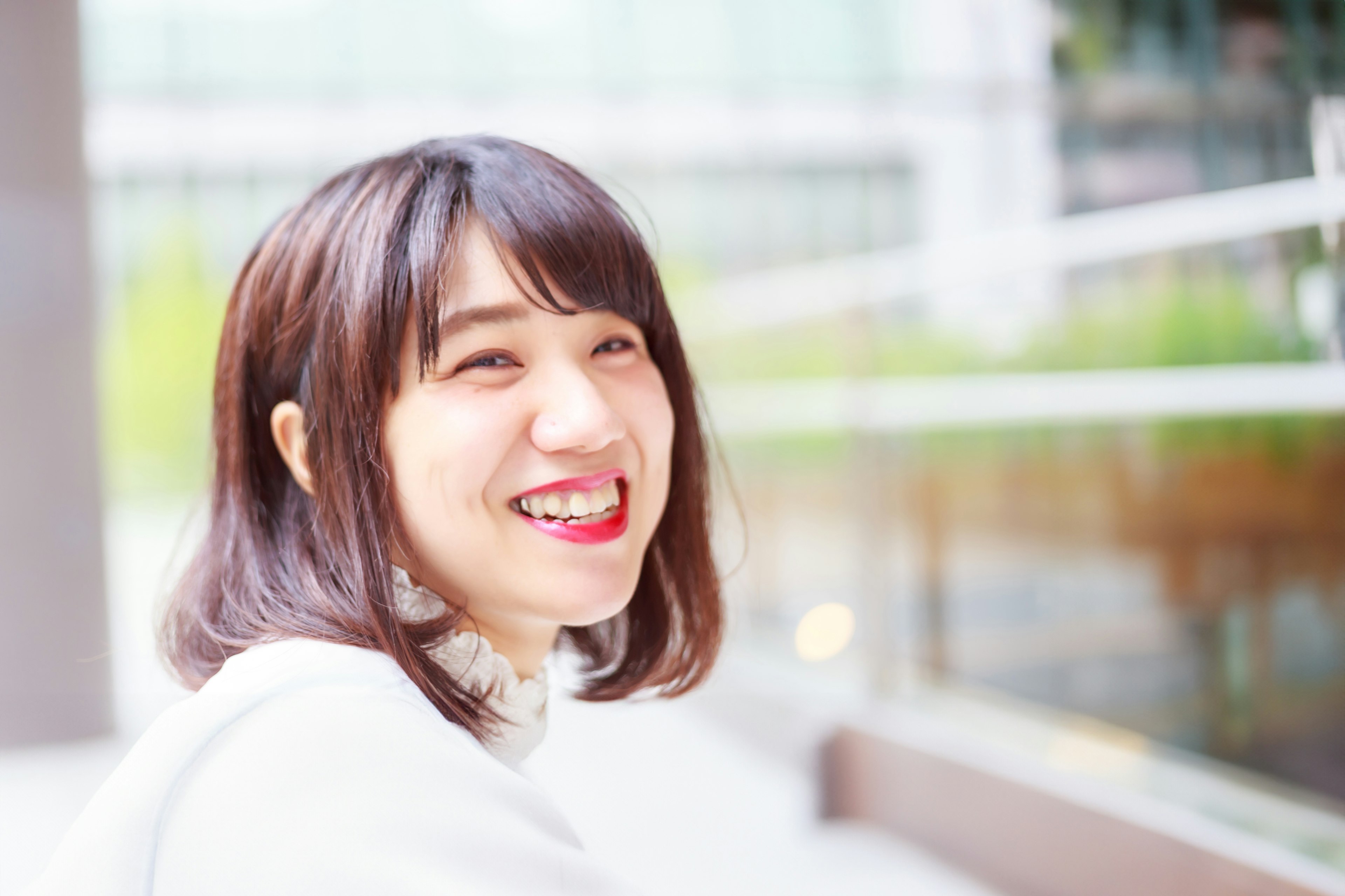 Smiling woman portrait with modern glass buildings in the background