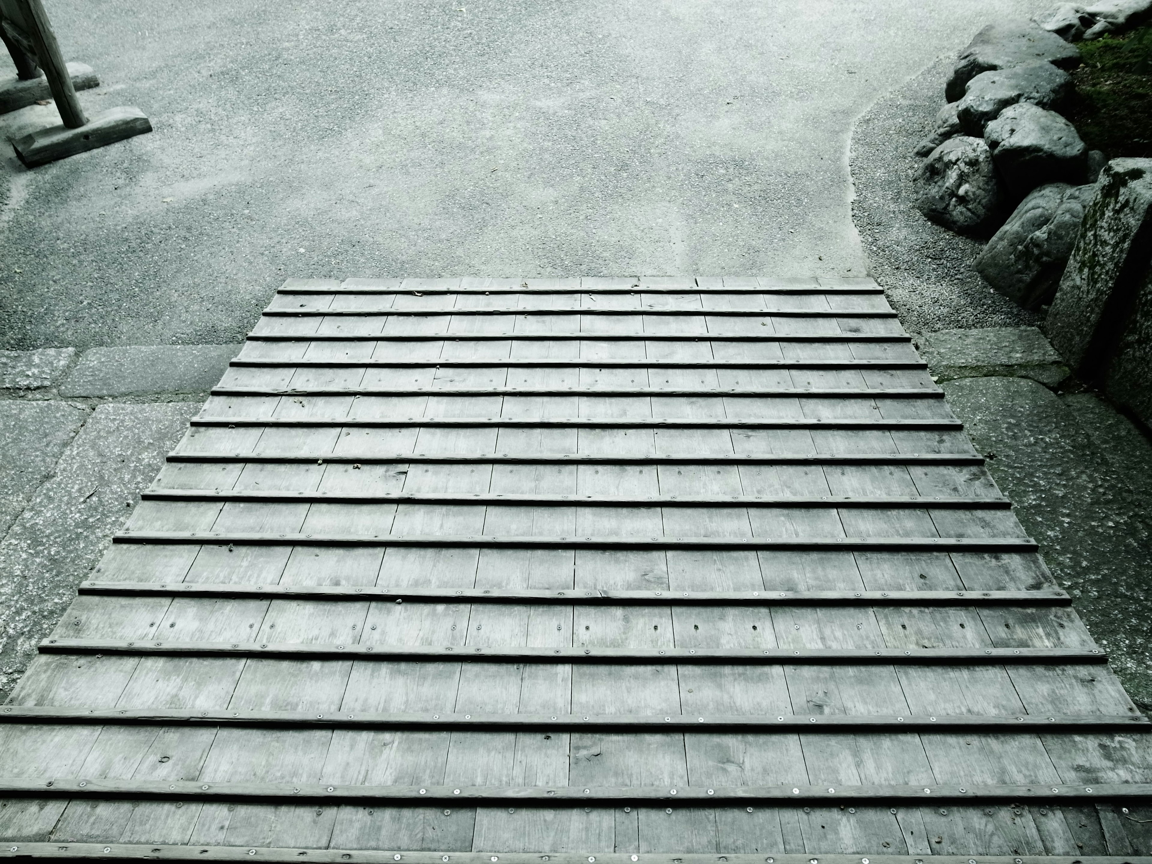 Wooden ramp leading to a stone-bordered path