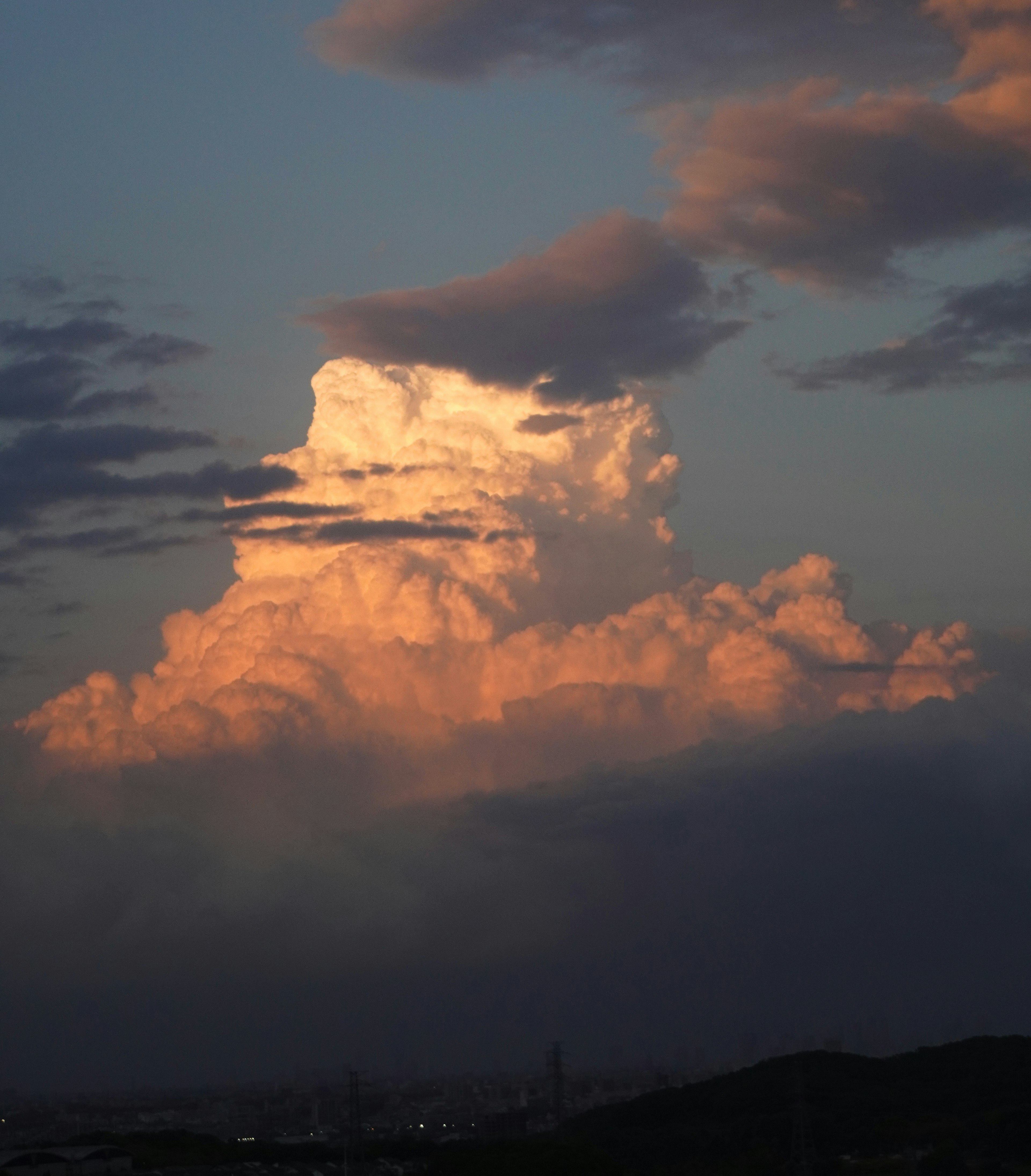 Langit dipenuhi awan yang diterangi oleh matahari terbenam