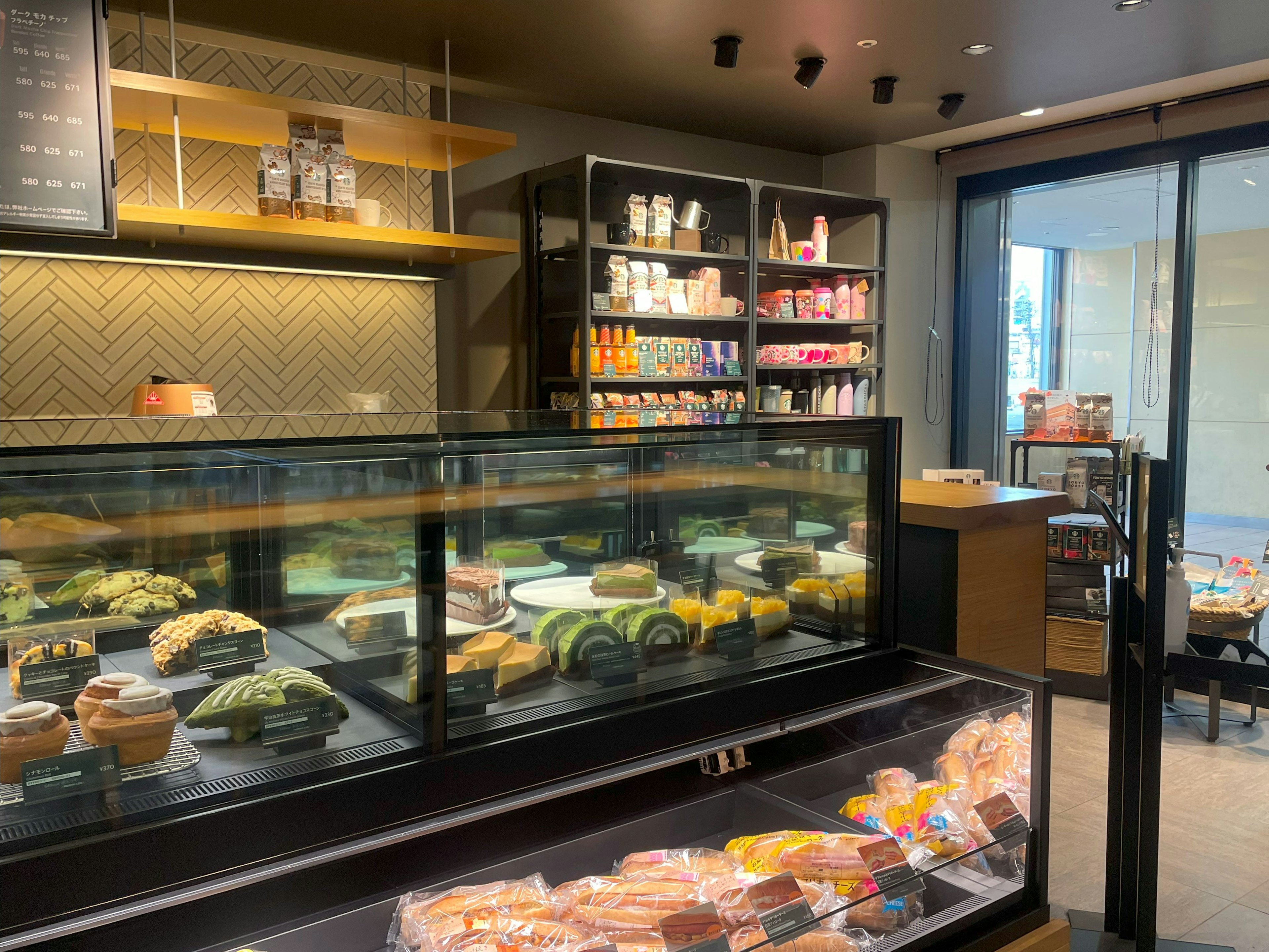 Interior of a bakery shop featuring a display case with fresh bread and pastries bright lighting and modern design