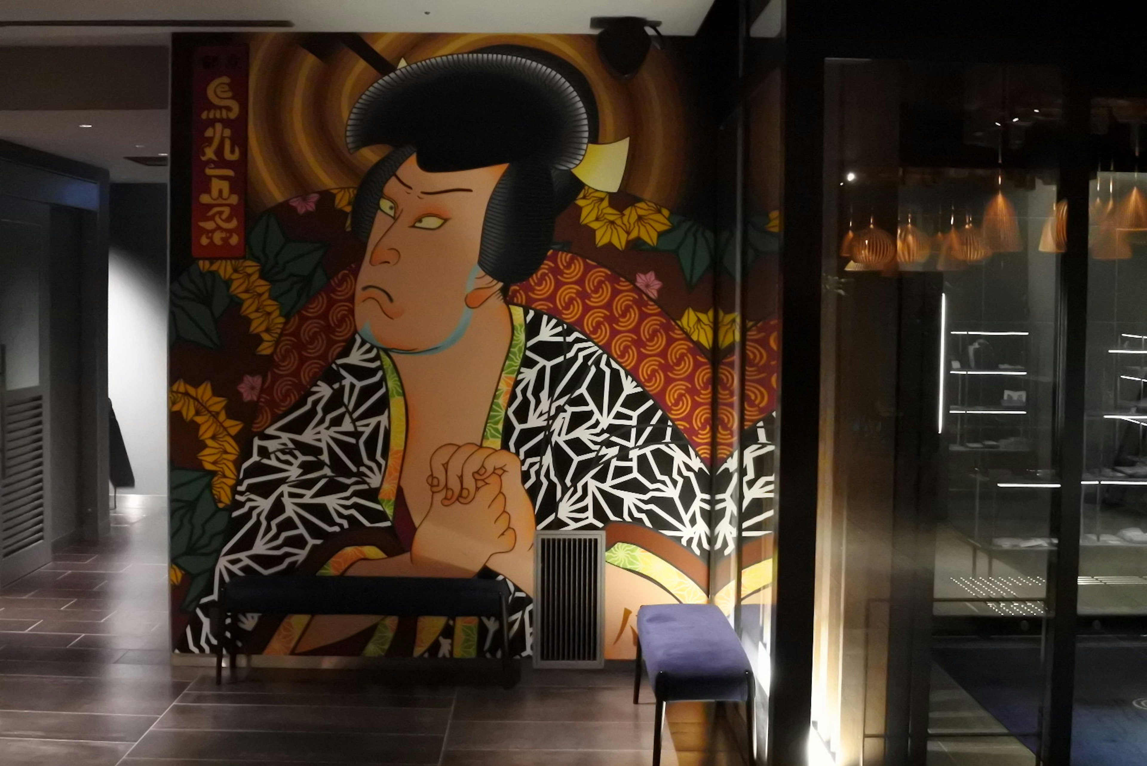 Vibrant mural of a Japanese woman with distinct style and colors in a modern interior