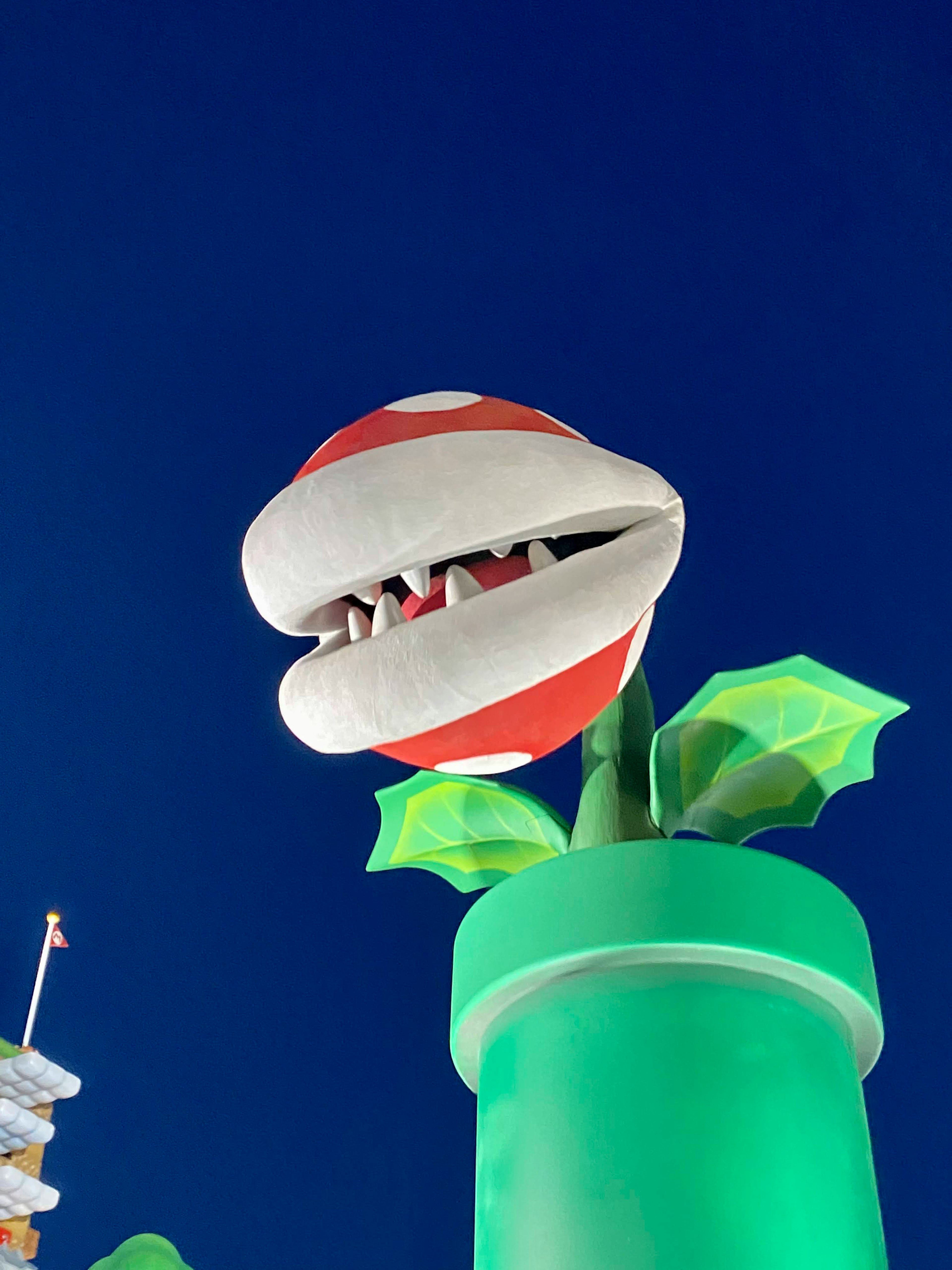 Piranha Plant emerging from green pipe against a night sky