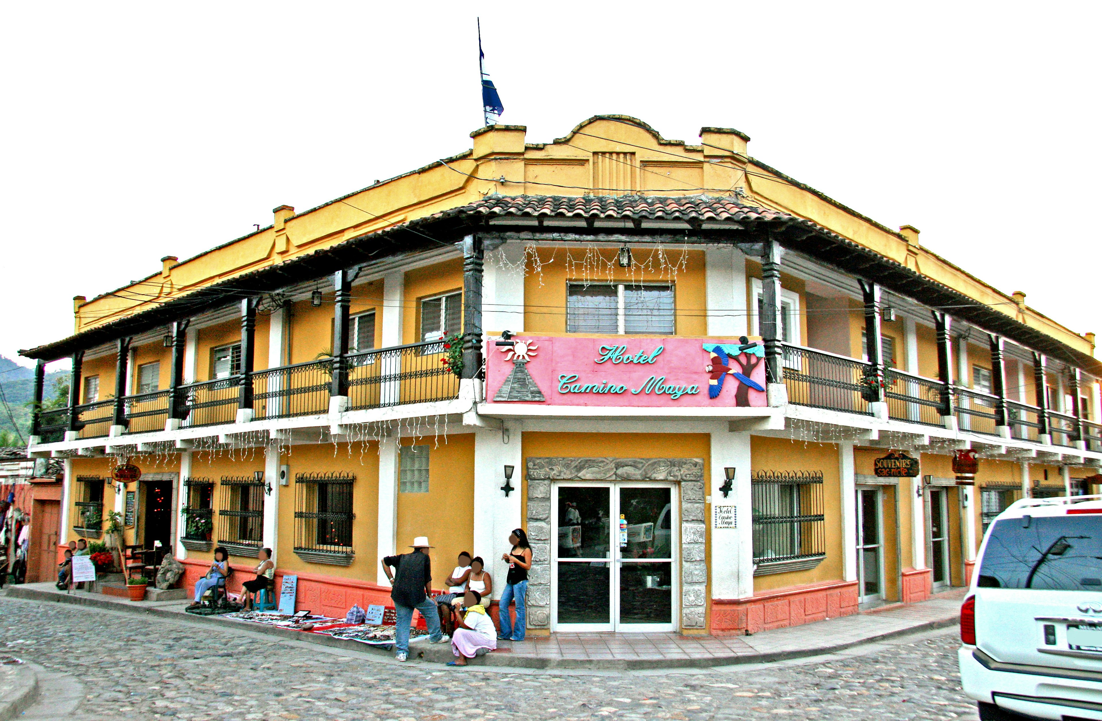 Colorful traditional Mexican building with balconies and a flag