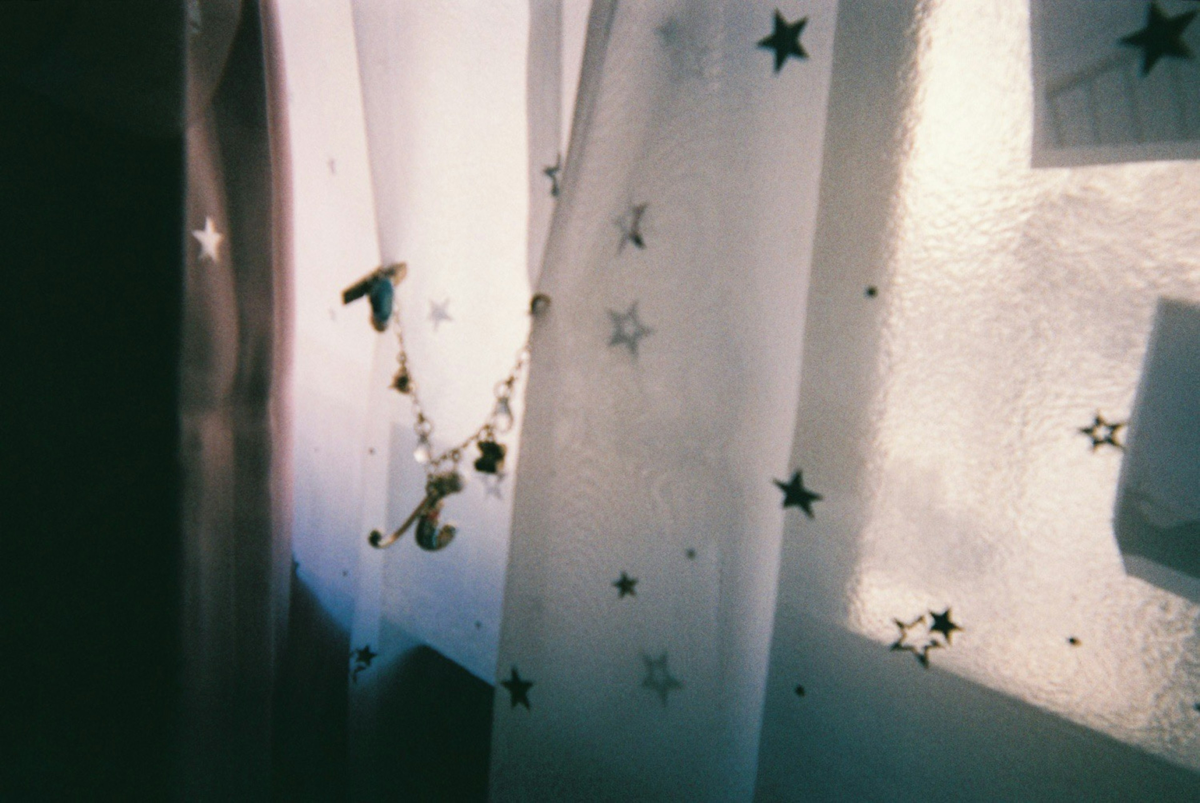 Light streaming through sheer curtains adorned with star patterns