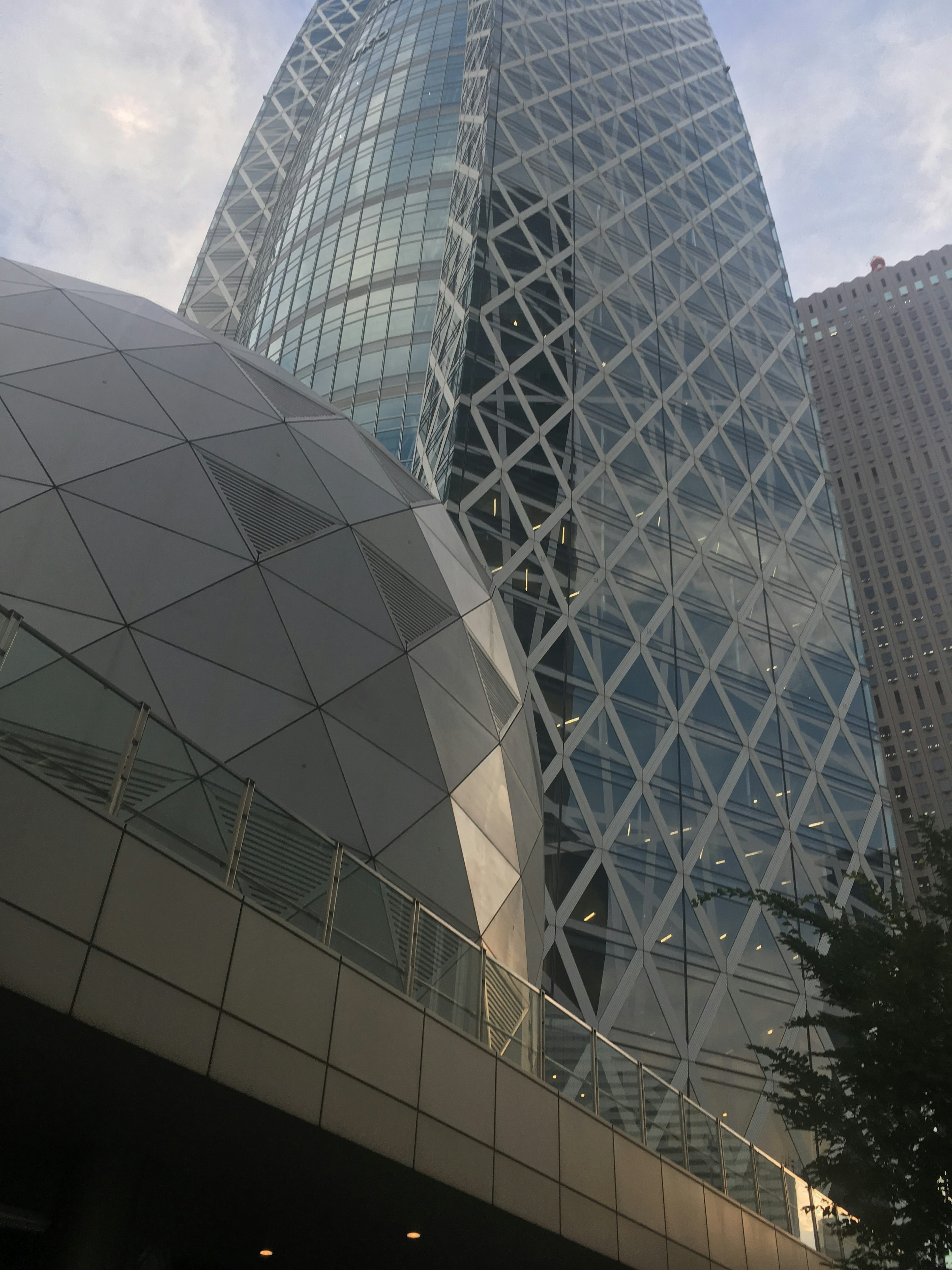 Paisaje urbano moderno con una cúpula geométrica y un alto edificio de vidrio