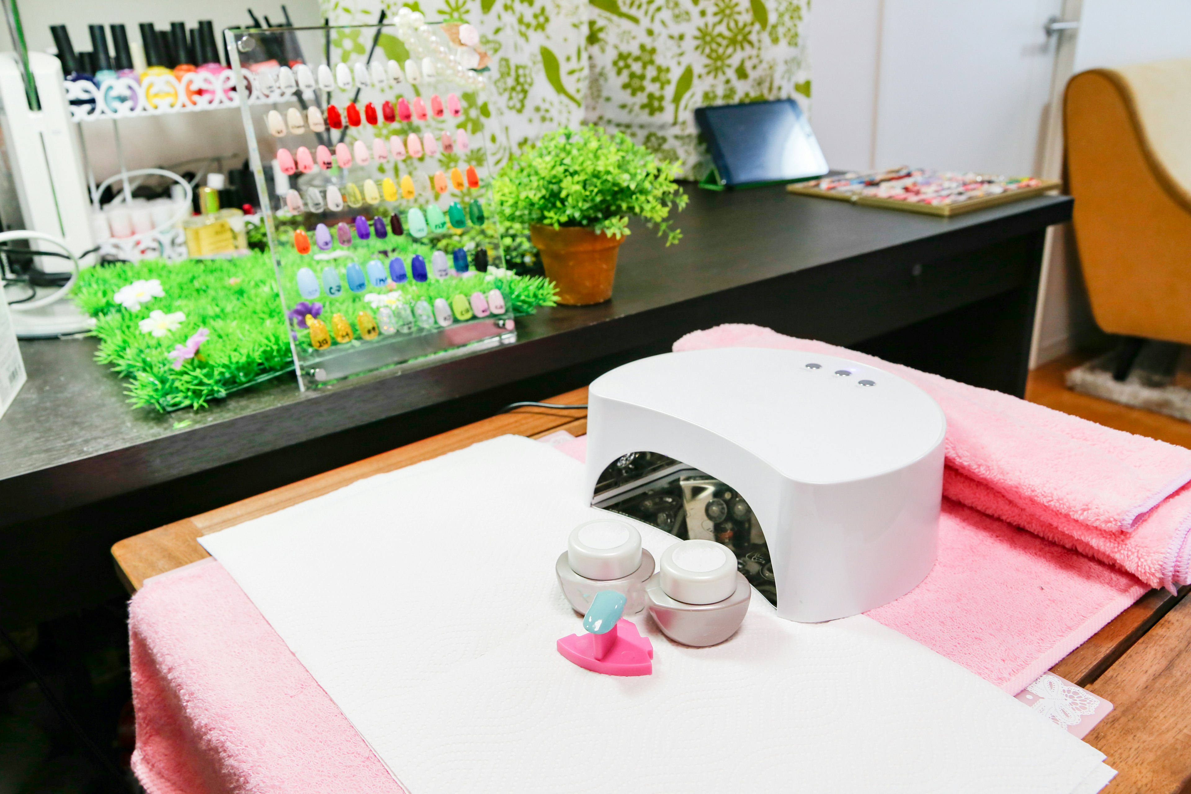 Nail salon workspace featuring colorful nail polishes and manicure supplies