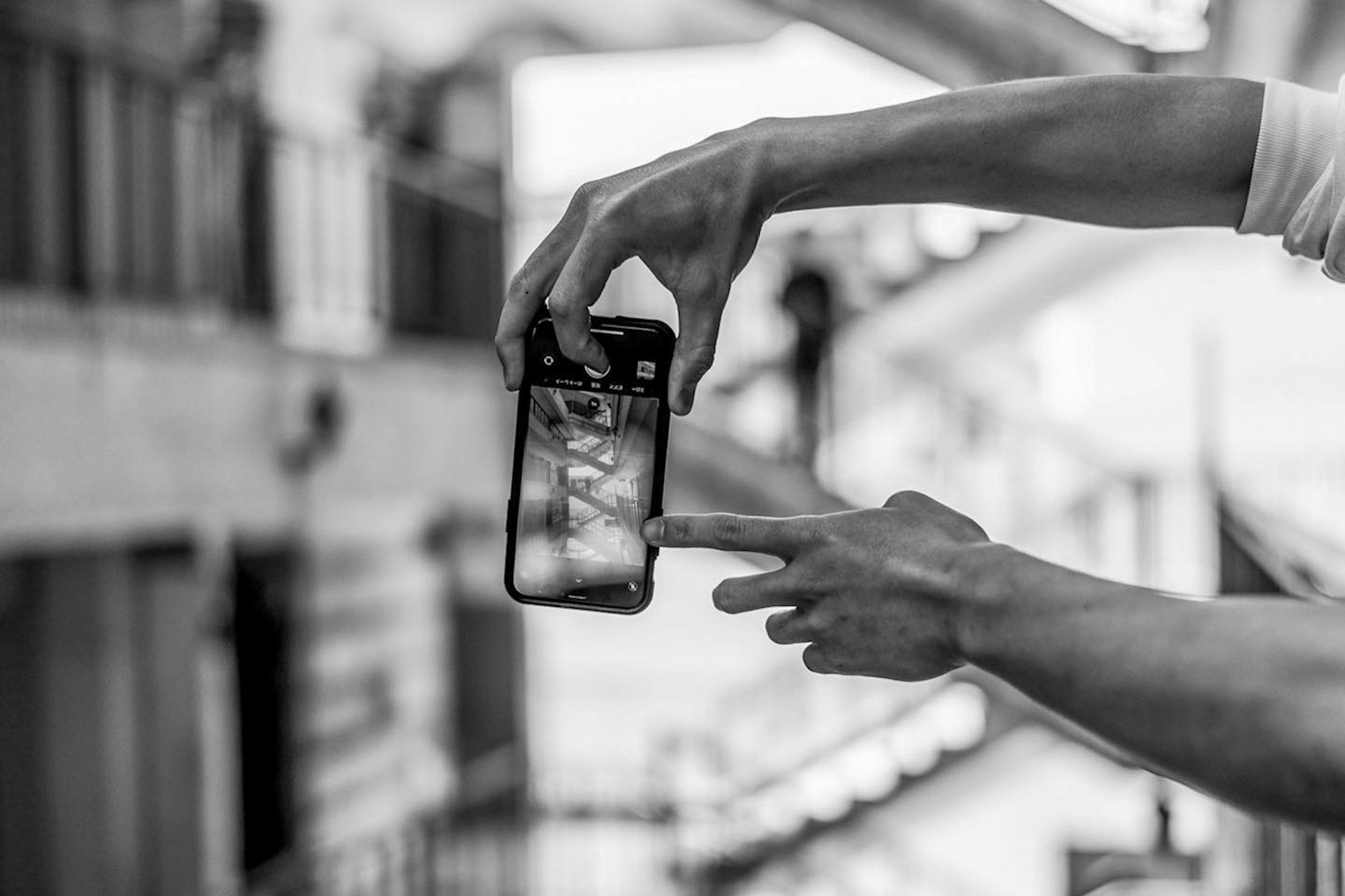 Close-up of a hand pointing at a smartphone screen