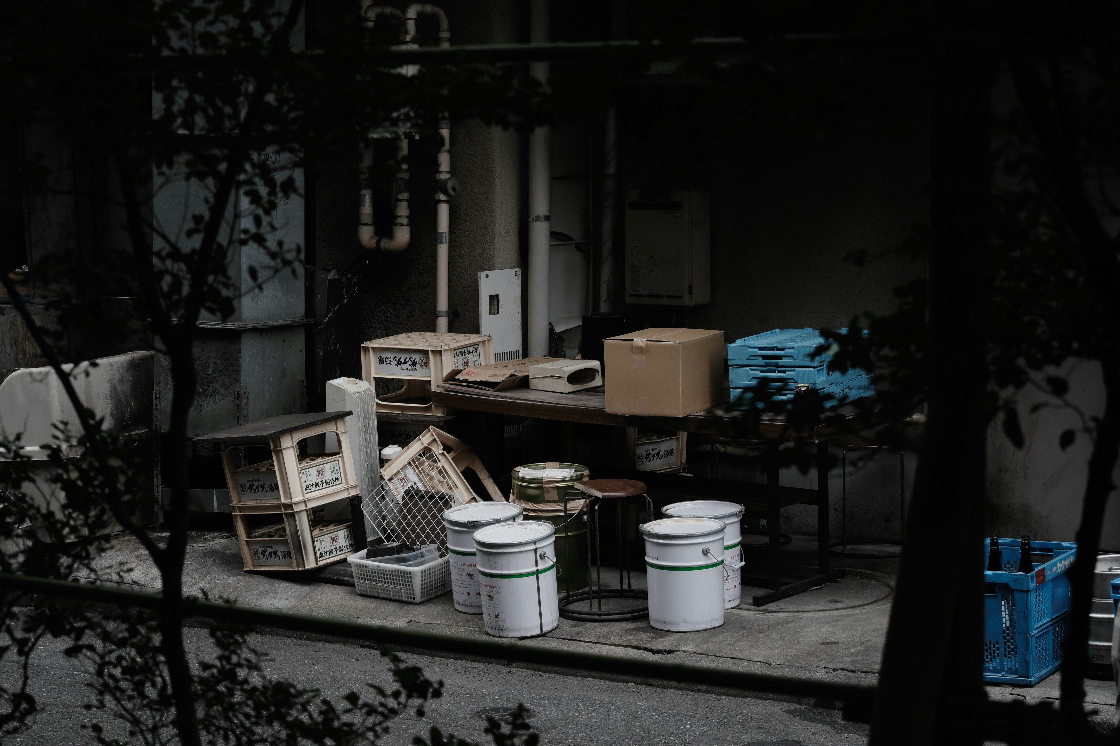 A collection of discarded items and tools in a dark setting