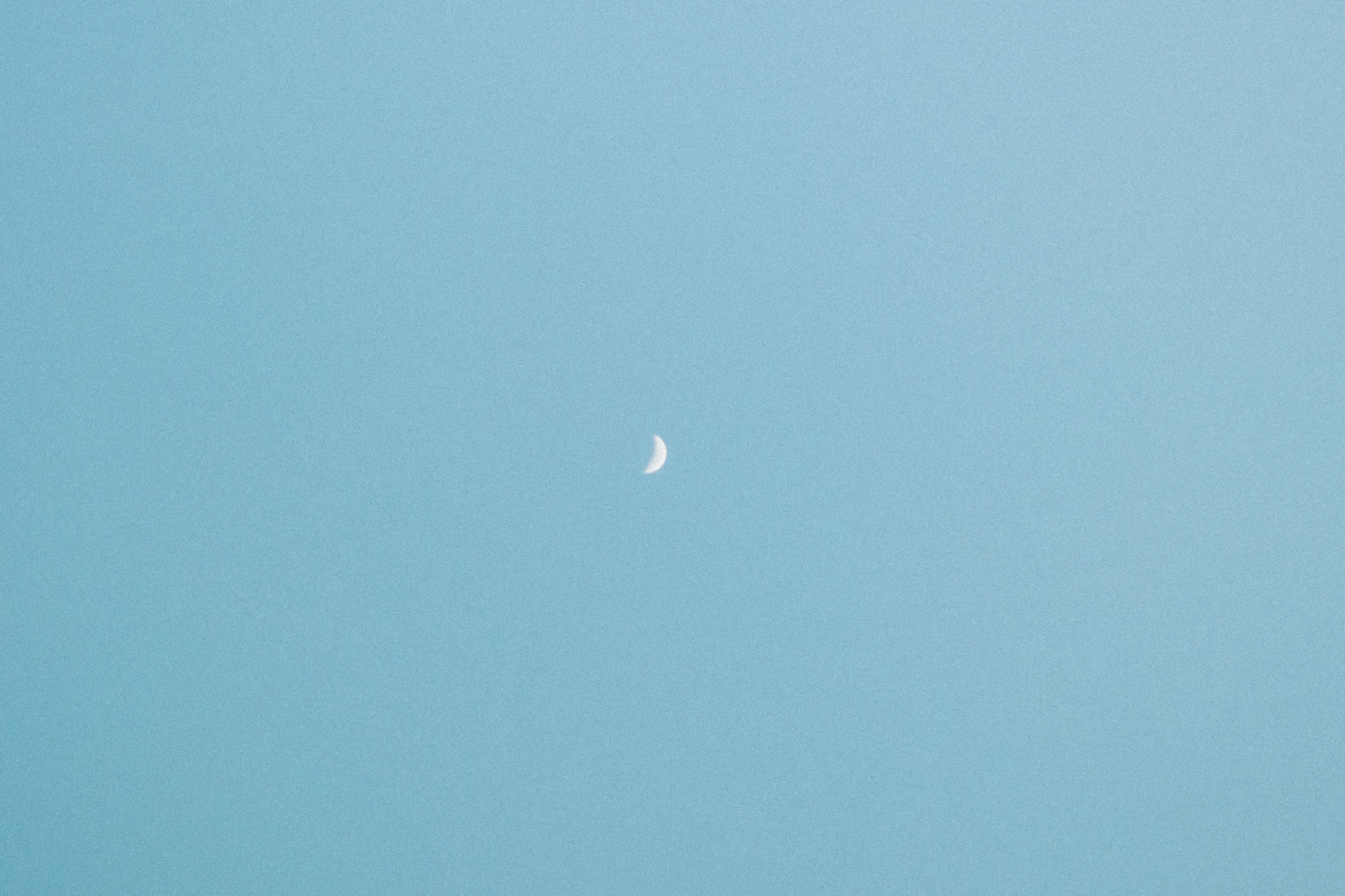 Small crescent moon in the blue sky