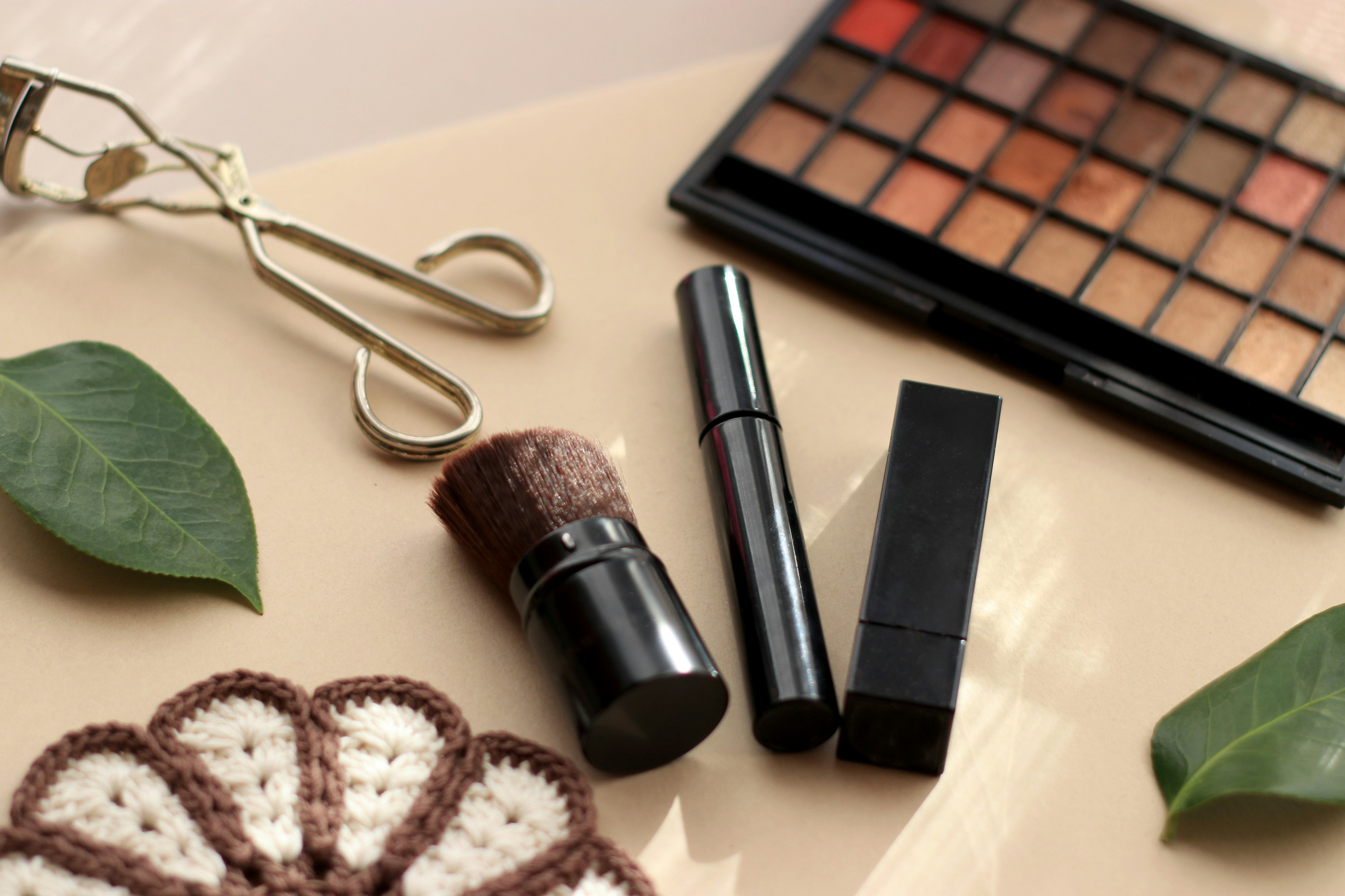 Still life featuring makeup tools and an eyeshadow palette