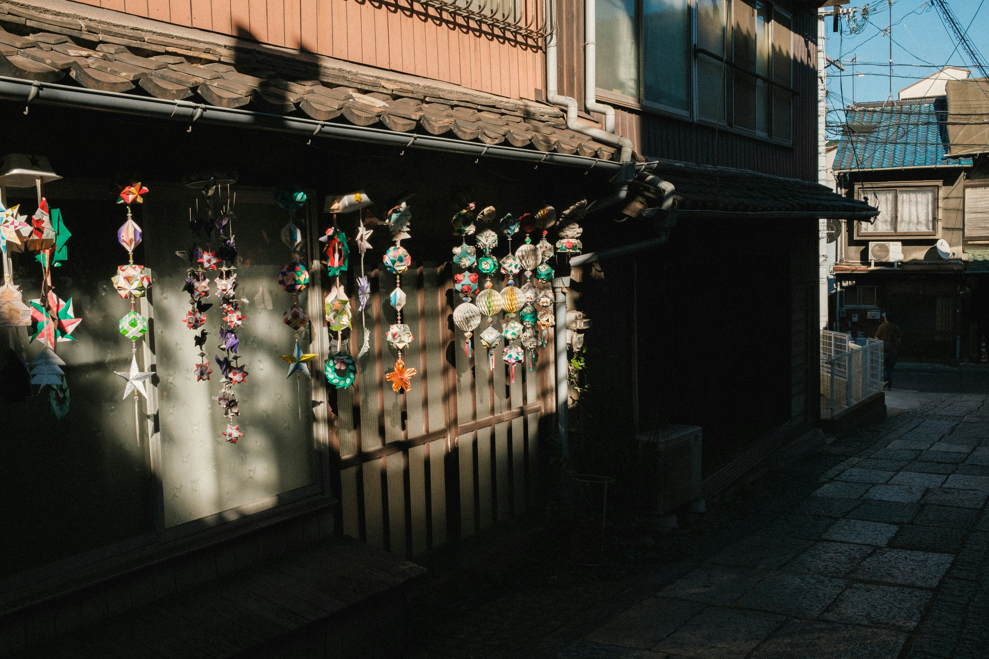 Colorful decorations hanging on the wall of an old town street