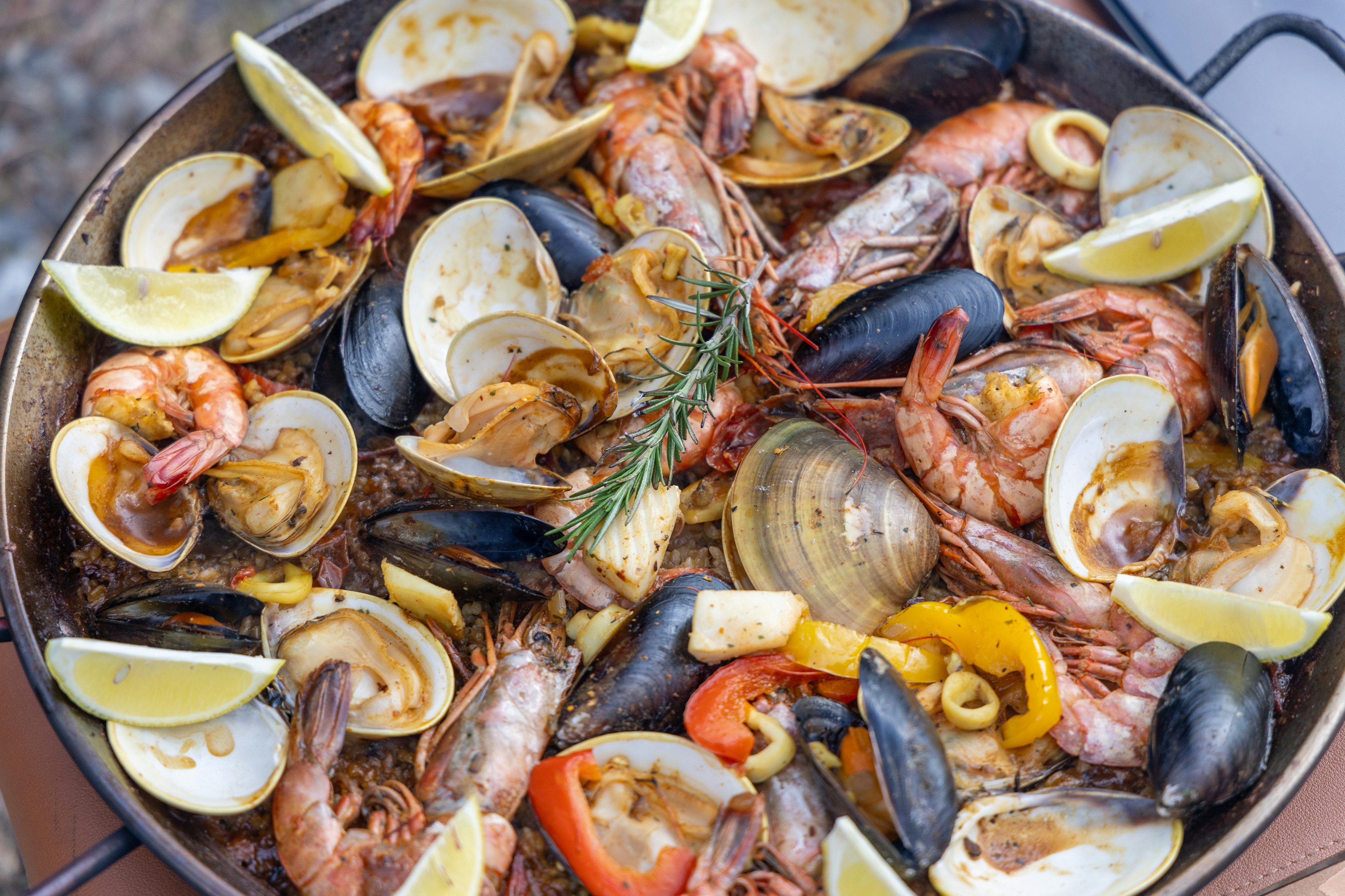 Seafood paella with lemon slices and vibrant ingredients