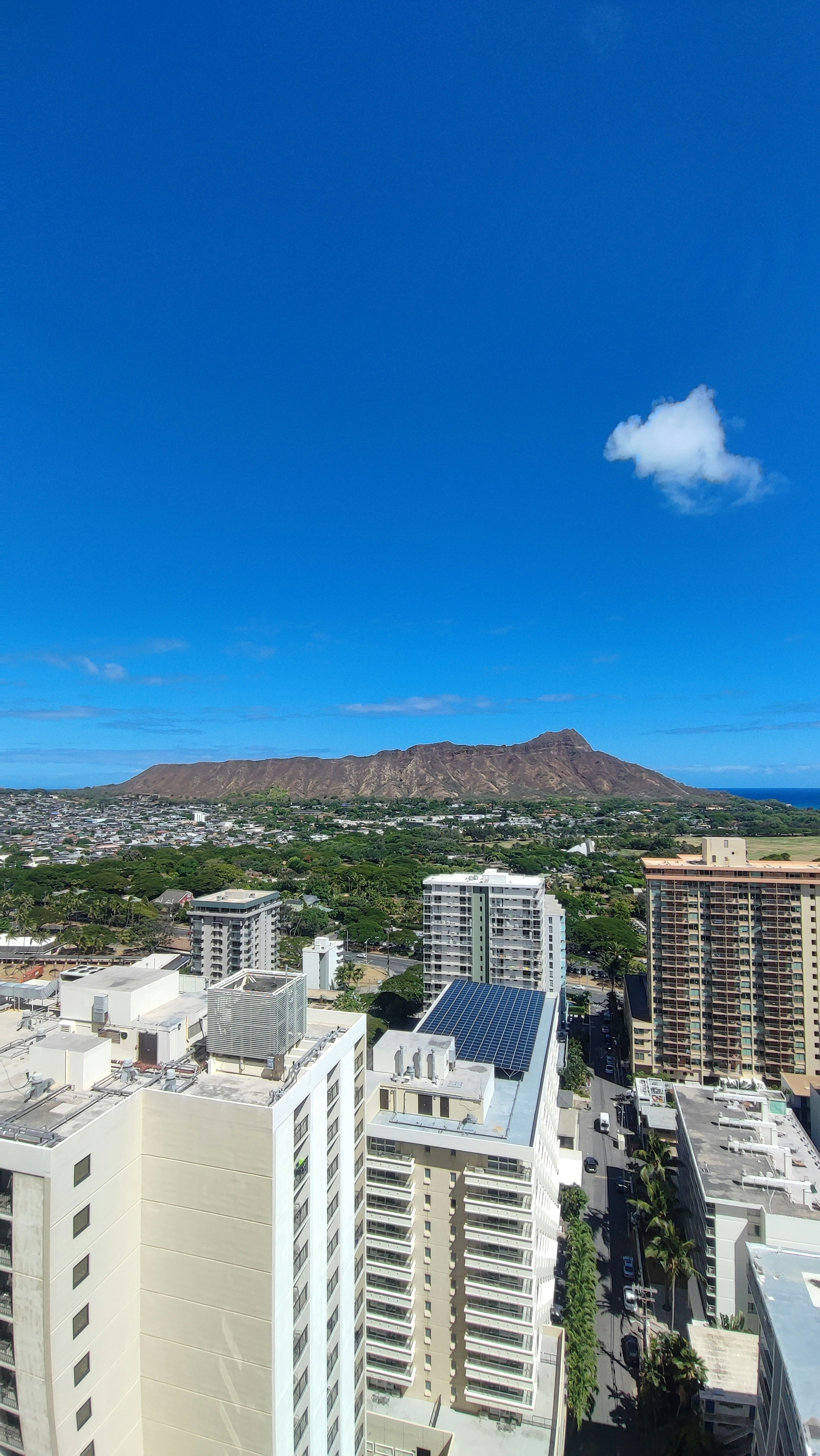 High-rise buildings overlooking Diamond Head and a clear blue sky