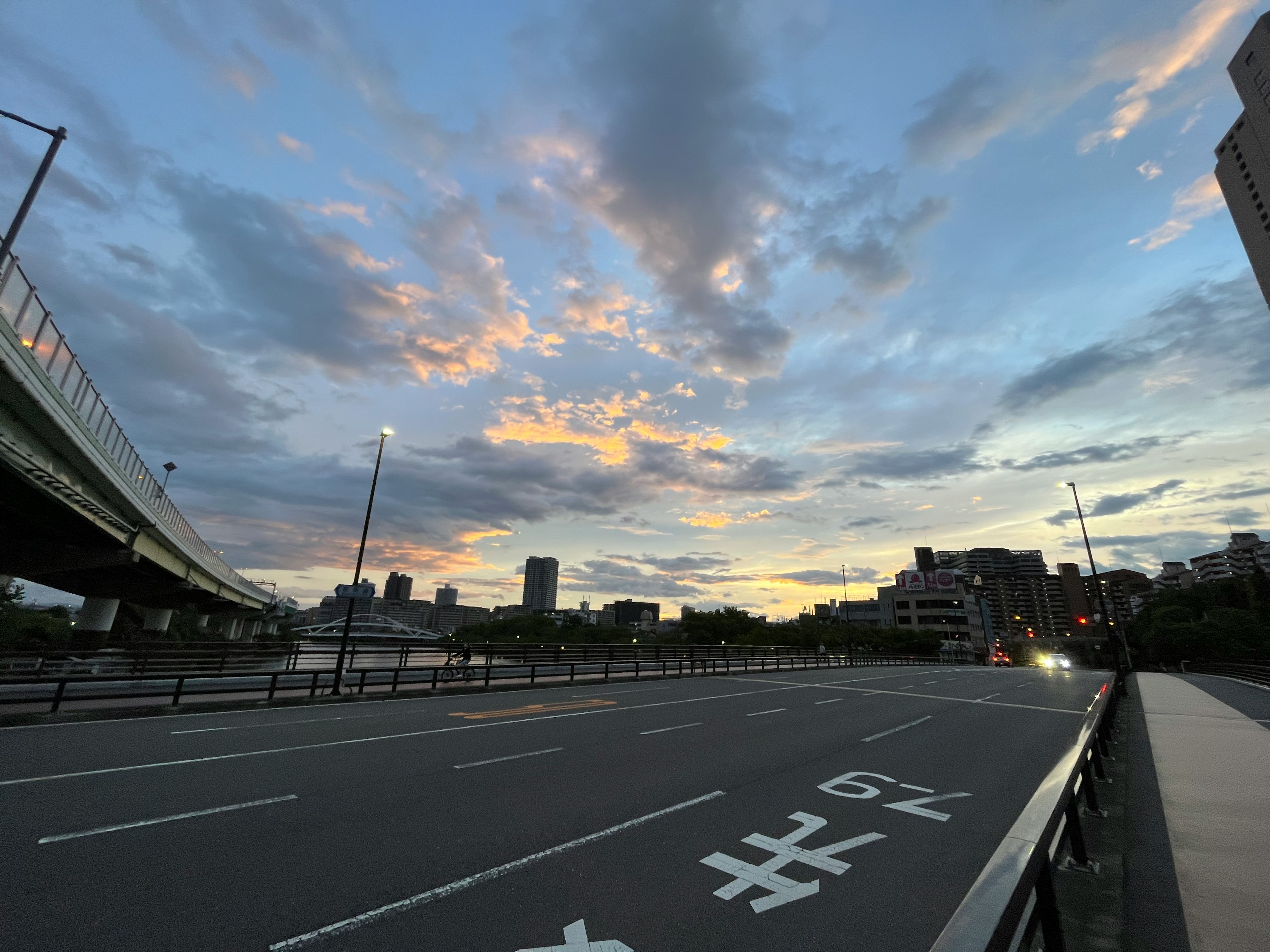 Urban landscape with a sunset sky and wide road