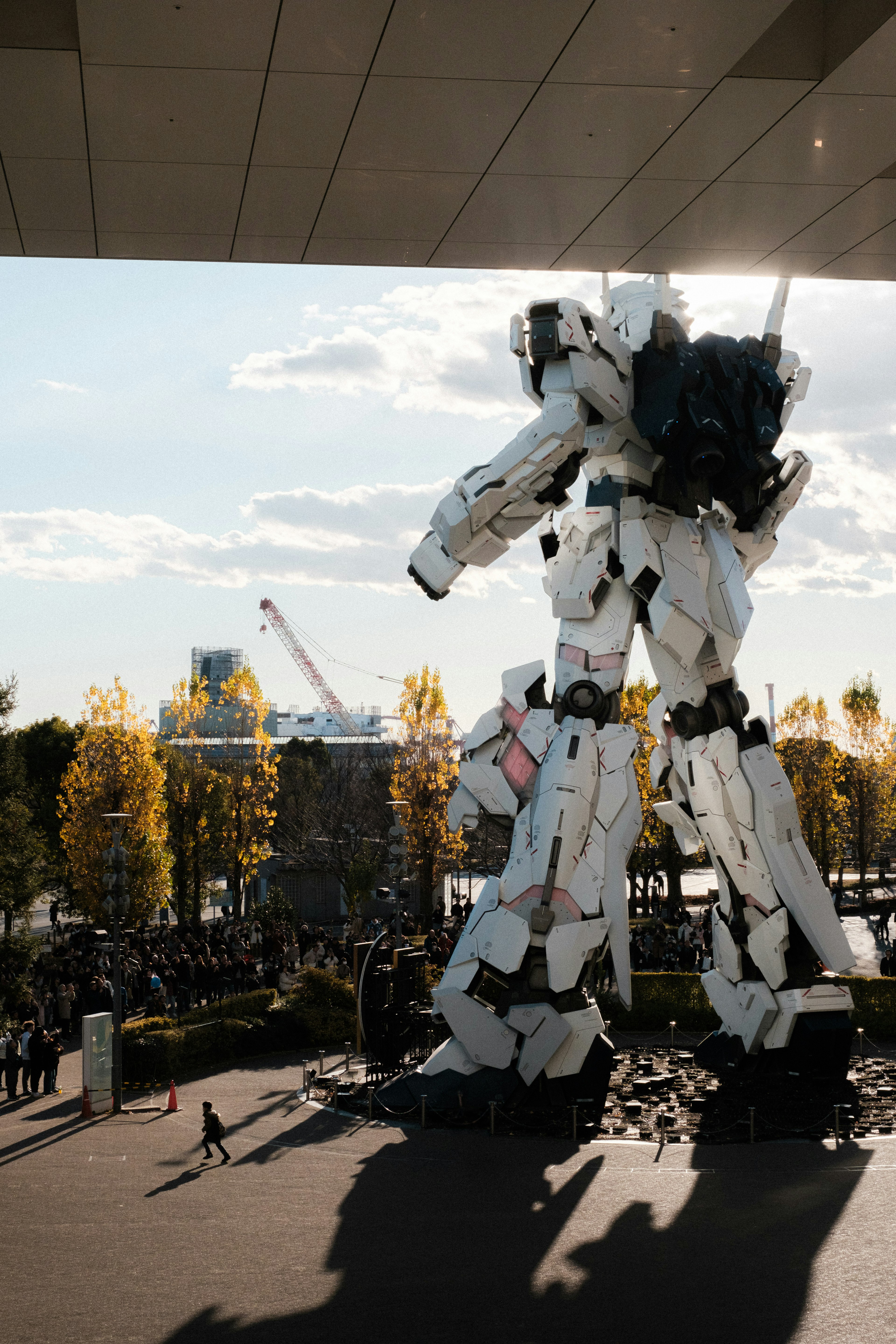 A large robot sculpture stands under a blue sky