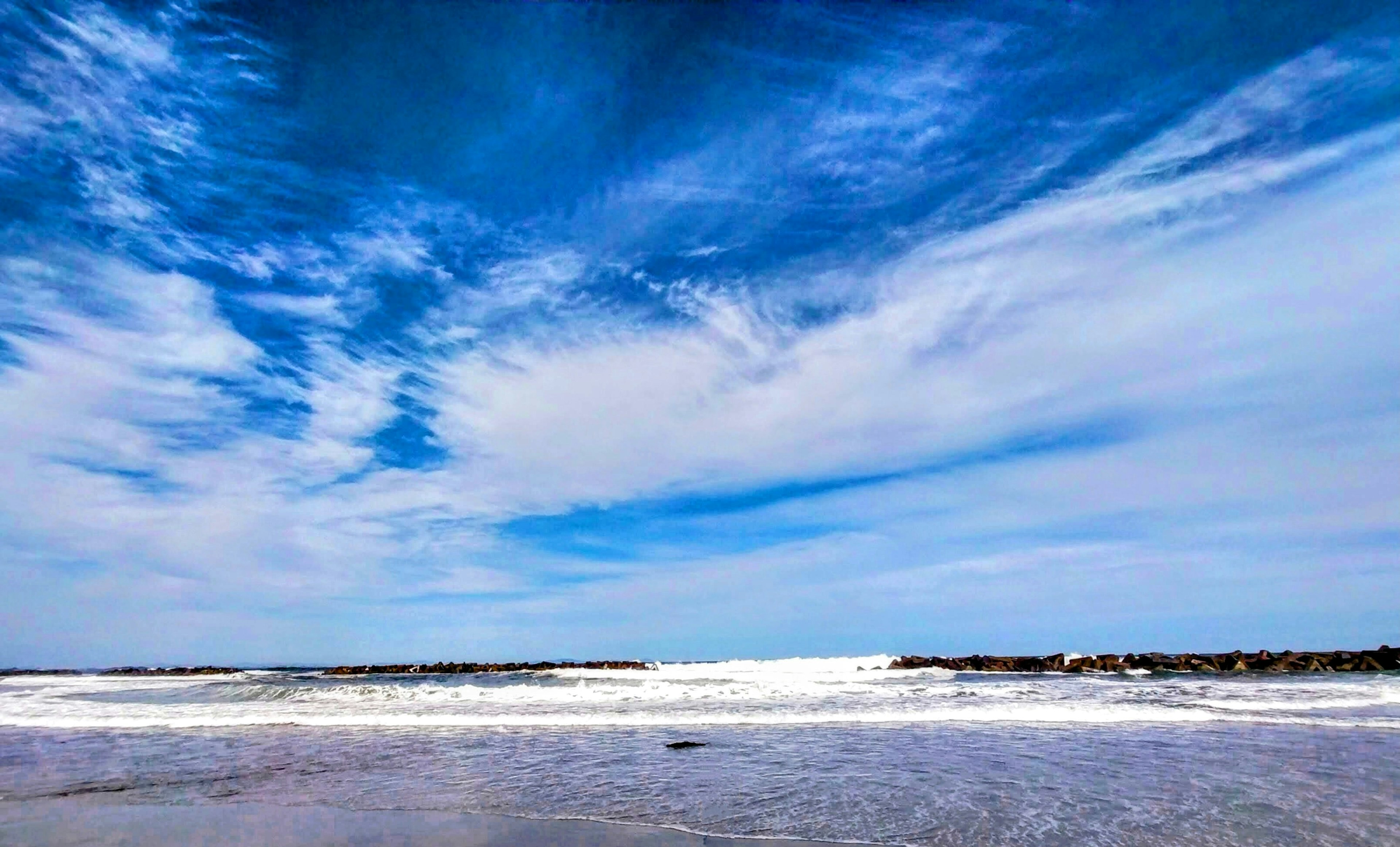 Scenic view of a blue sky and ocean waves