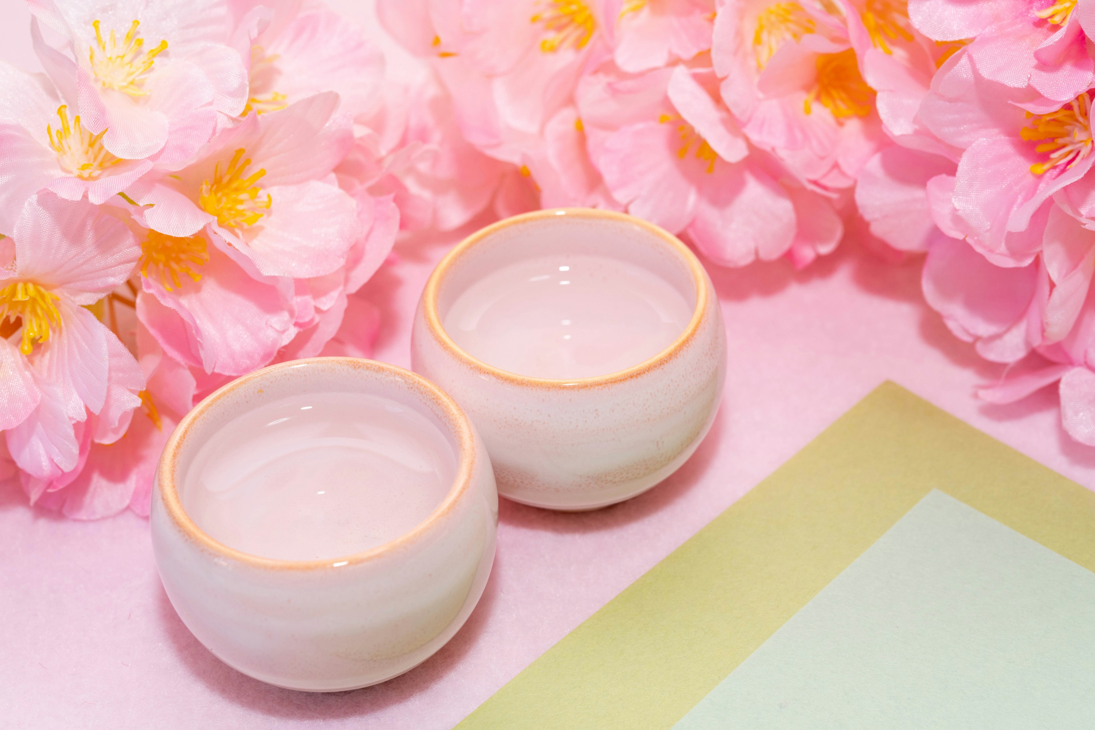 Beautiful image featuring pink flowers and white ceramic bowls