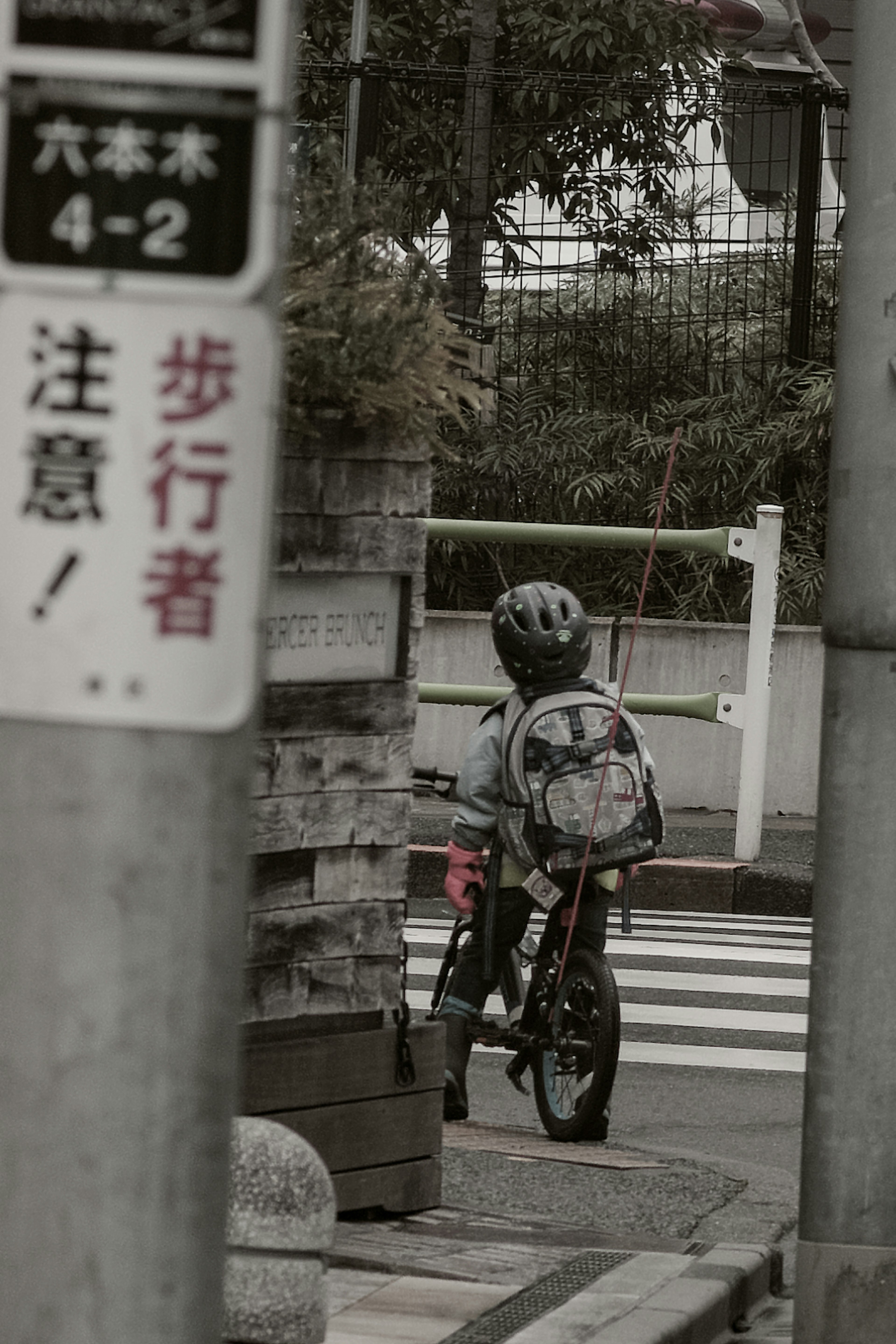 Child riding a bicycle with traffic signs in the background