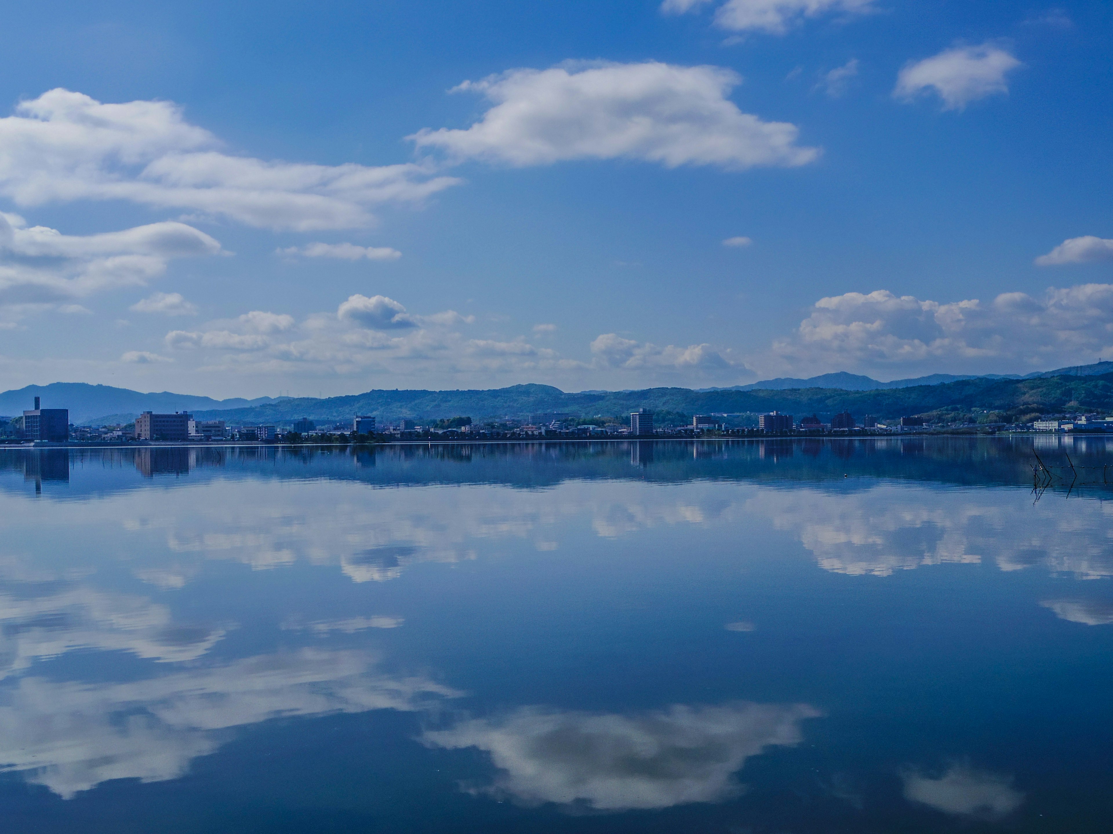 青い空と雲の反射が美しい湖の風景