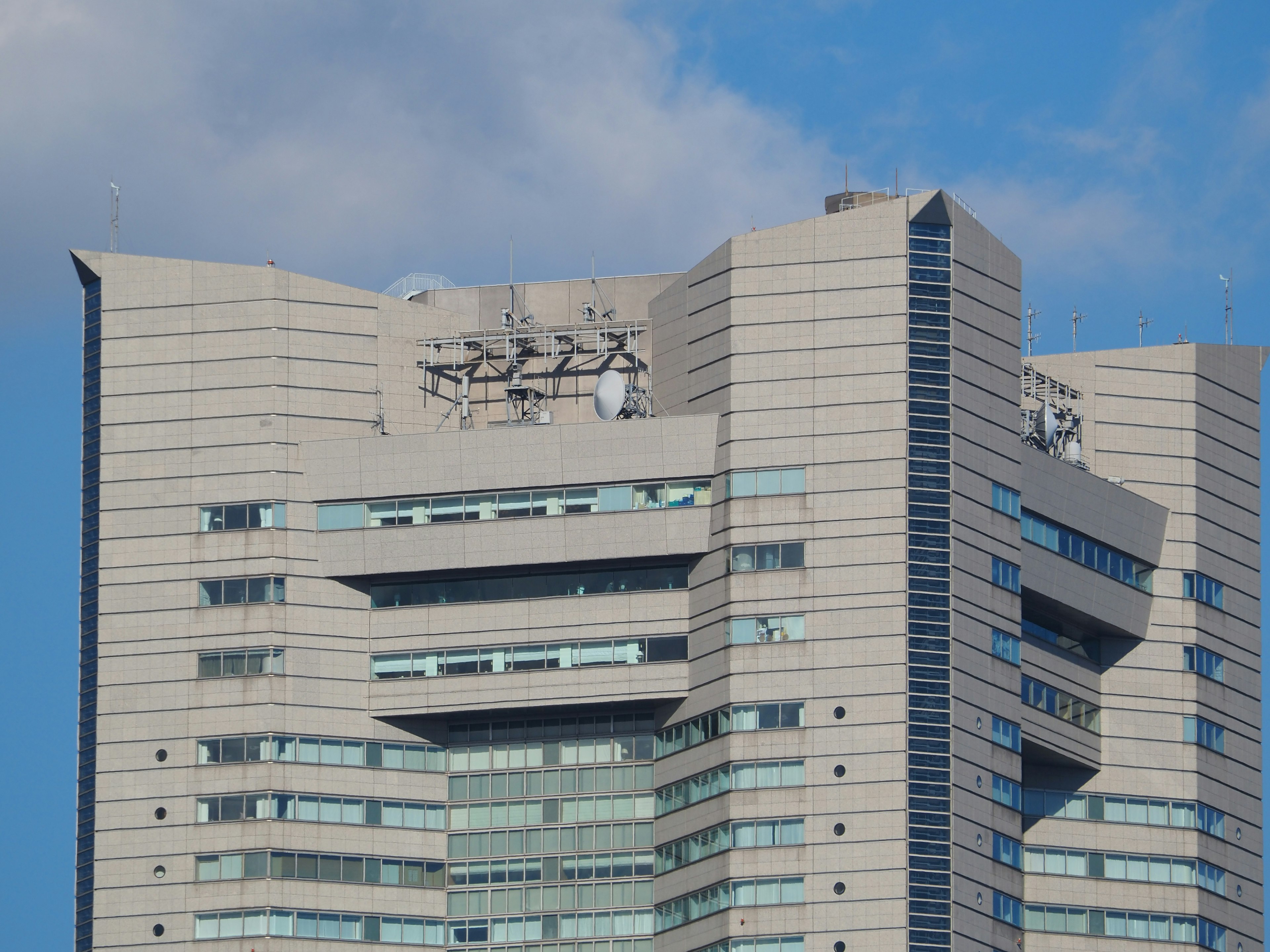 Close-up of a skyscraper showcasing windows and metallic details