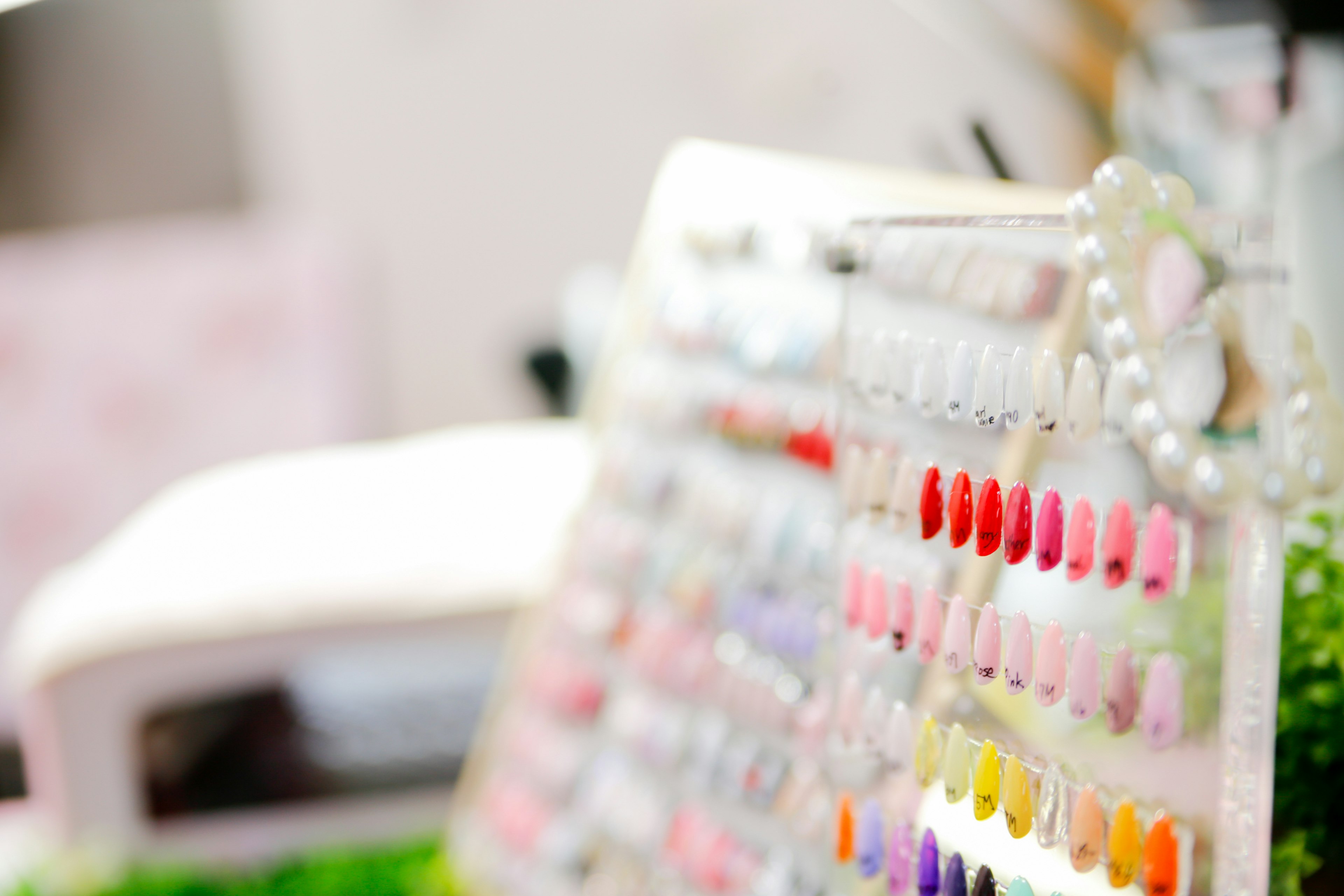 Nail salon color swatch board displaying various shades of nail polish