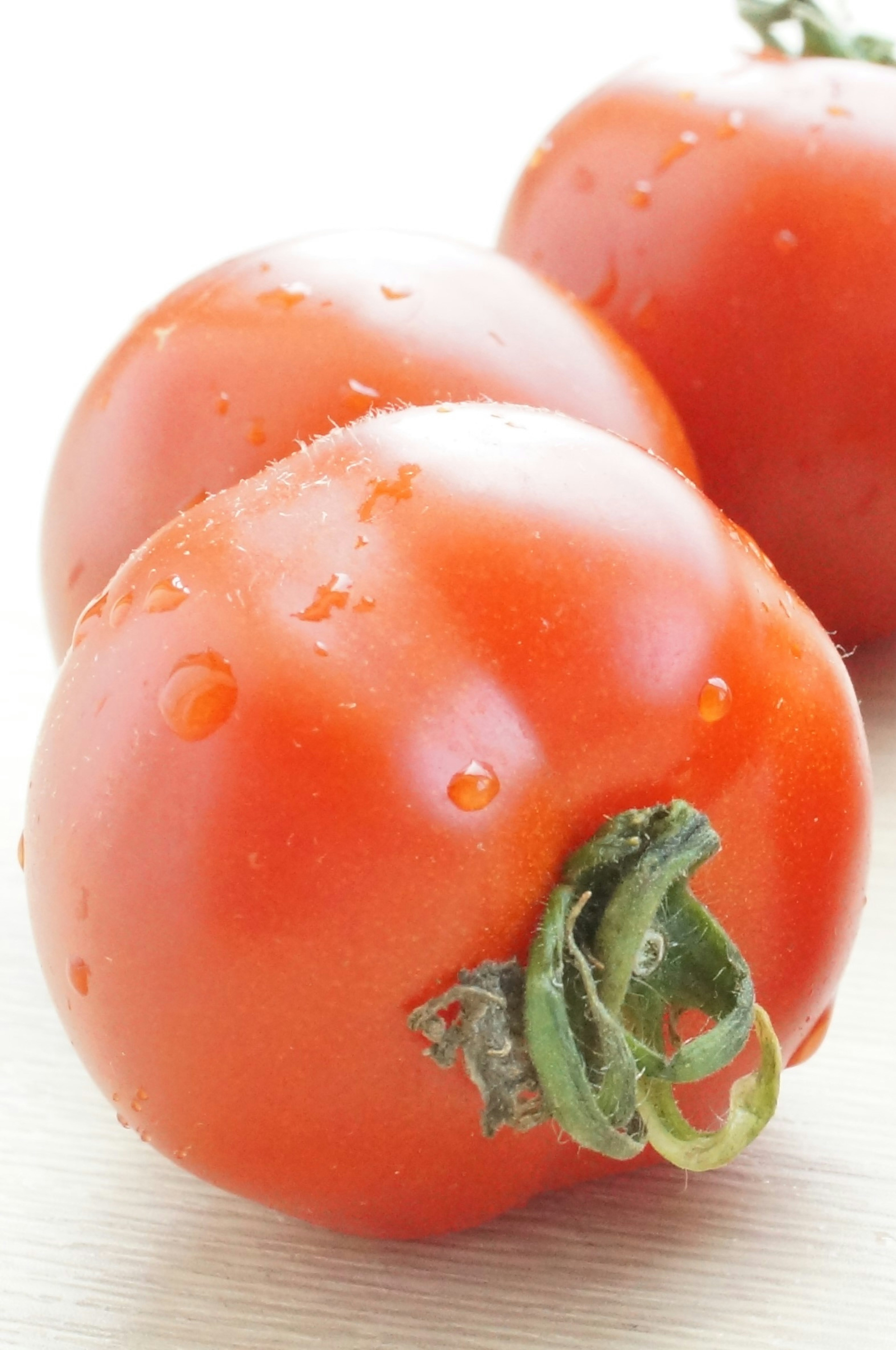 Fresh tomatoes with droplets arranged together