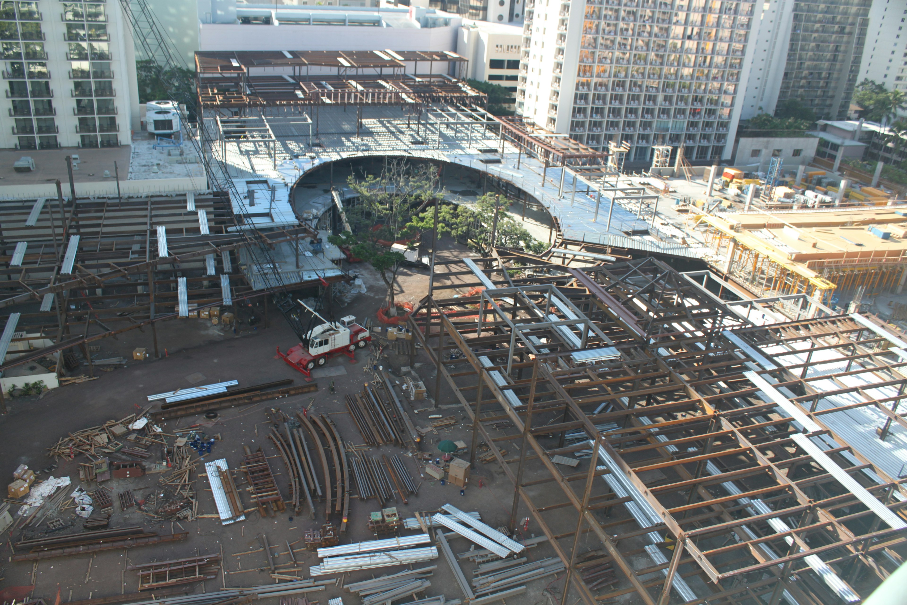 Overview of a construction site featuring steel structures construction machinery and surrounding skyscrapers