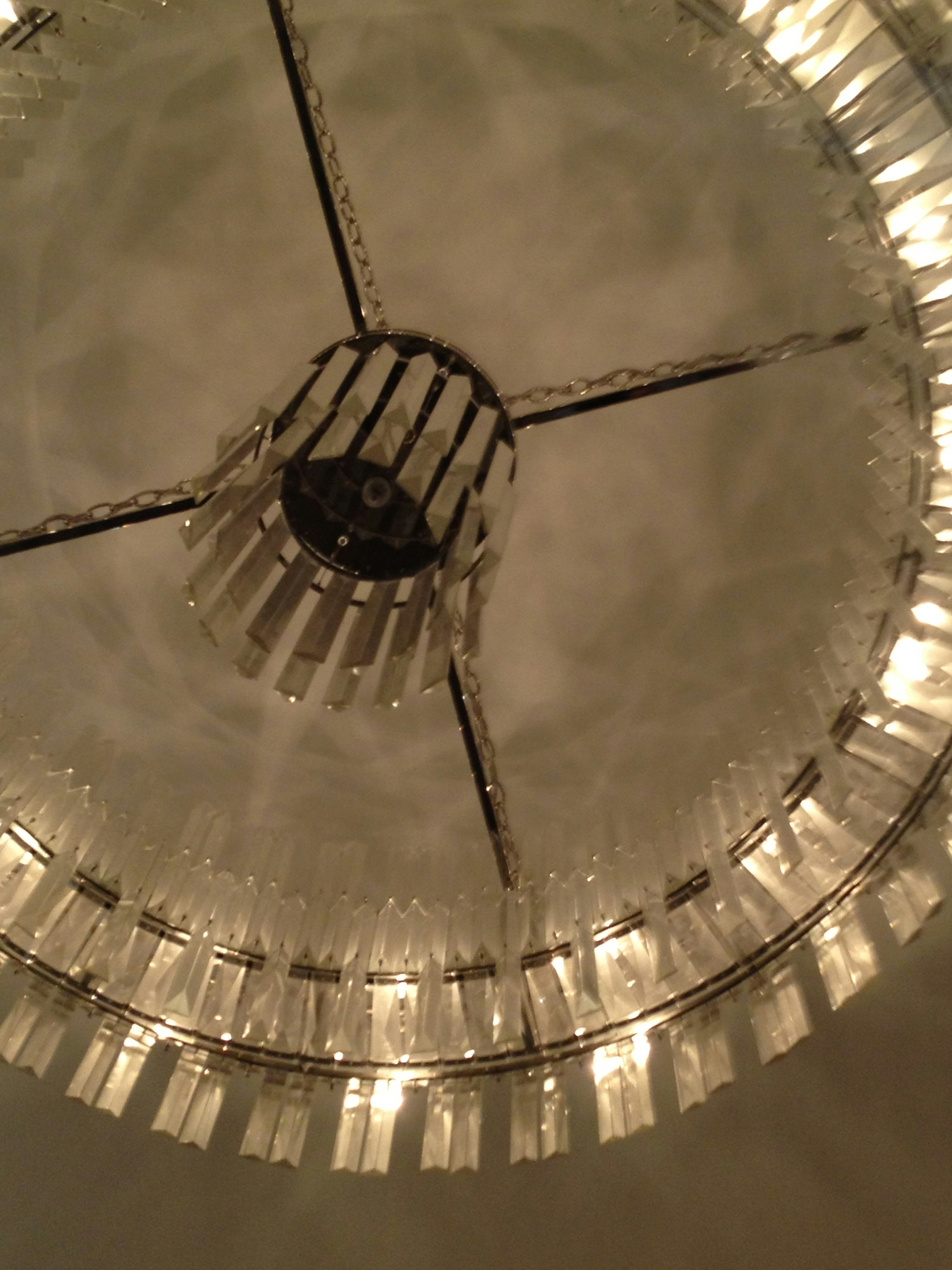 View of an elegant chandelier from below showcasing beautiful light reflections