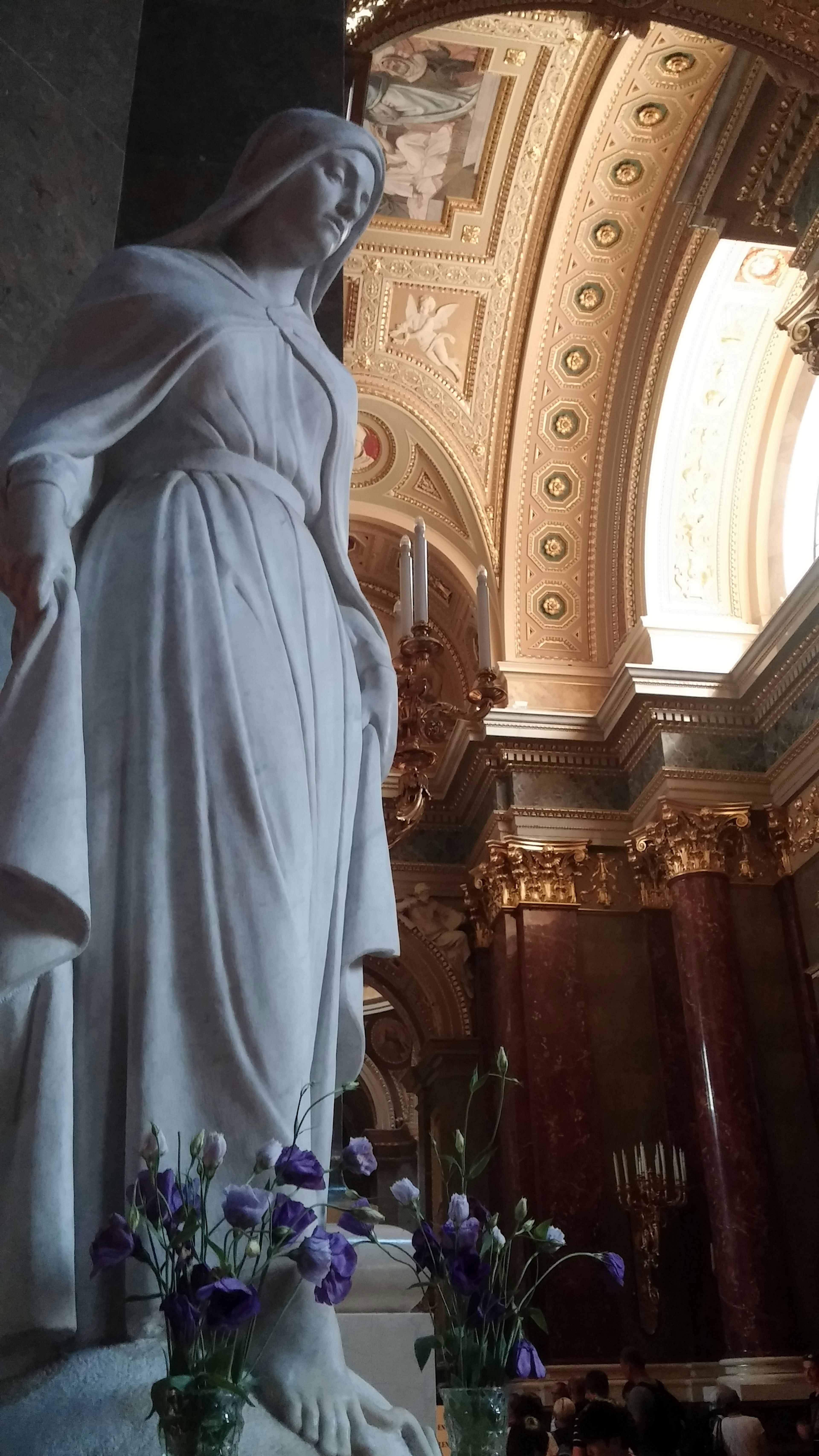 Marble statue with flowers in a church interior